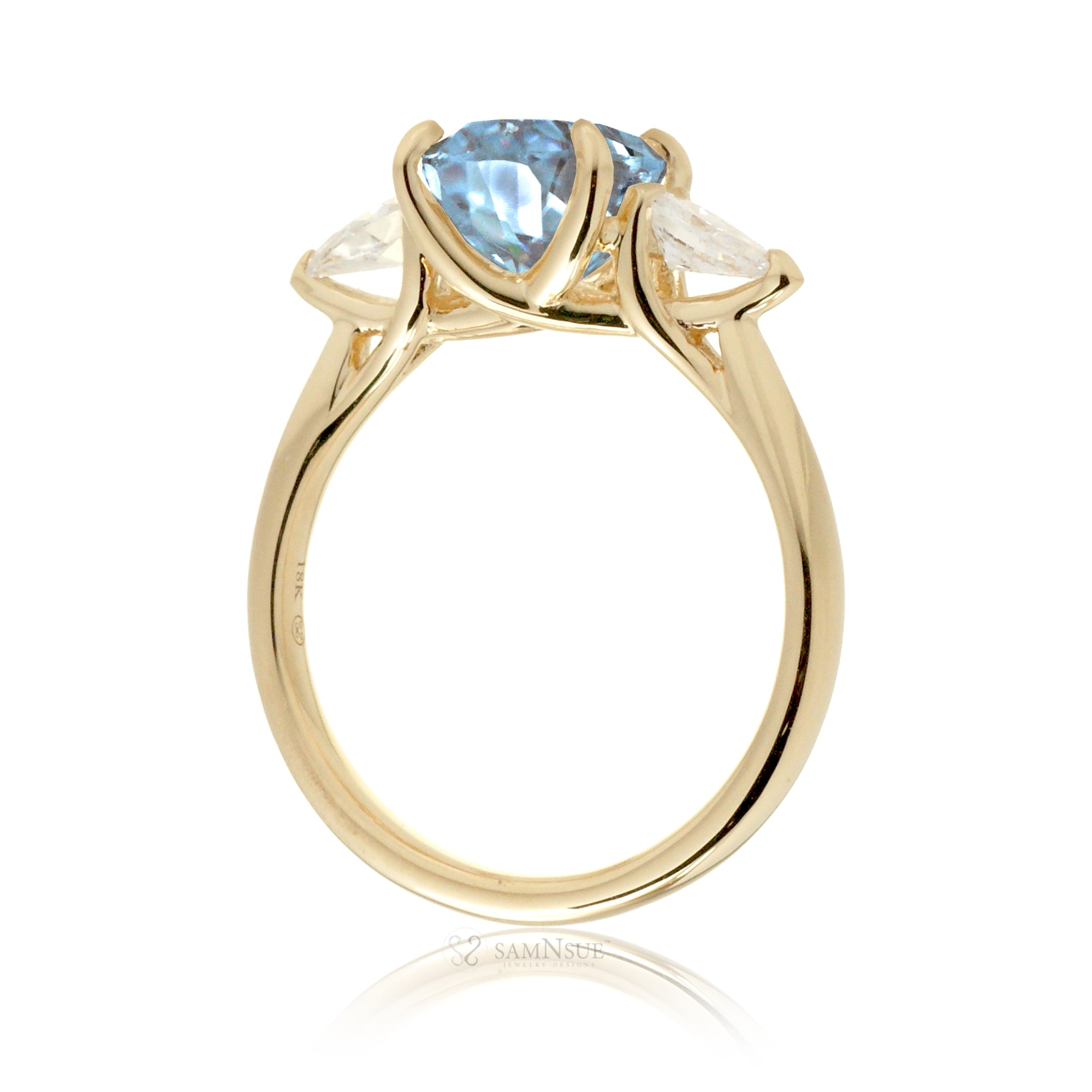 Oval aquamarine proposal ring with pear side diamonds yellow gold