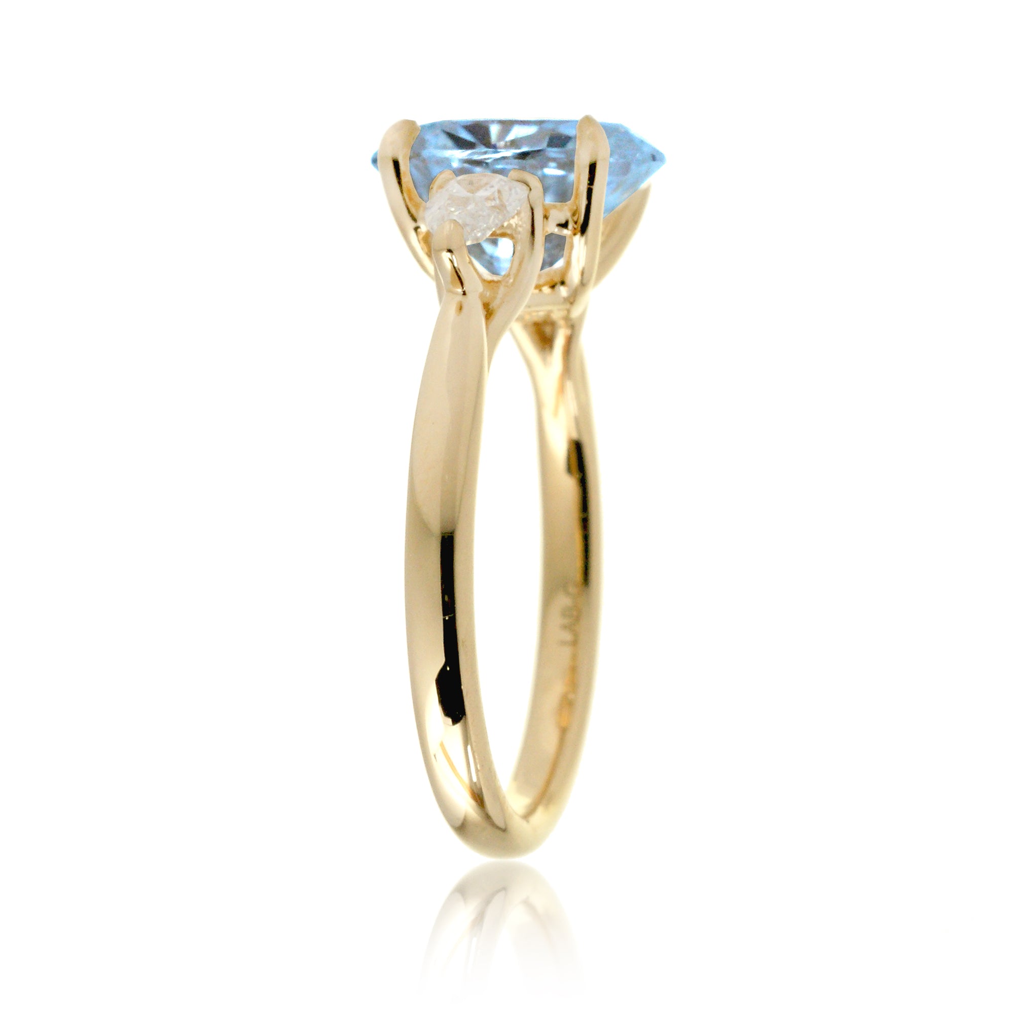 Oval aquamarine proposal ring with pear side diamonds yellow gold