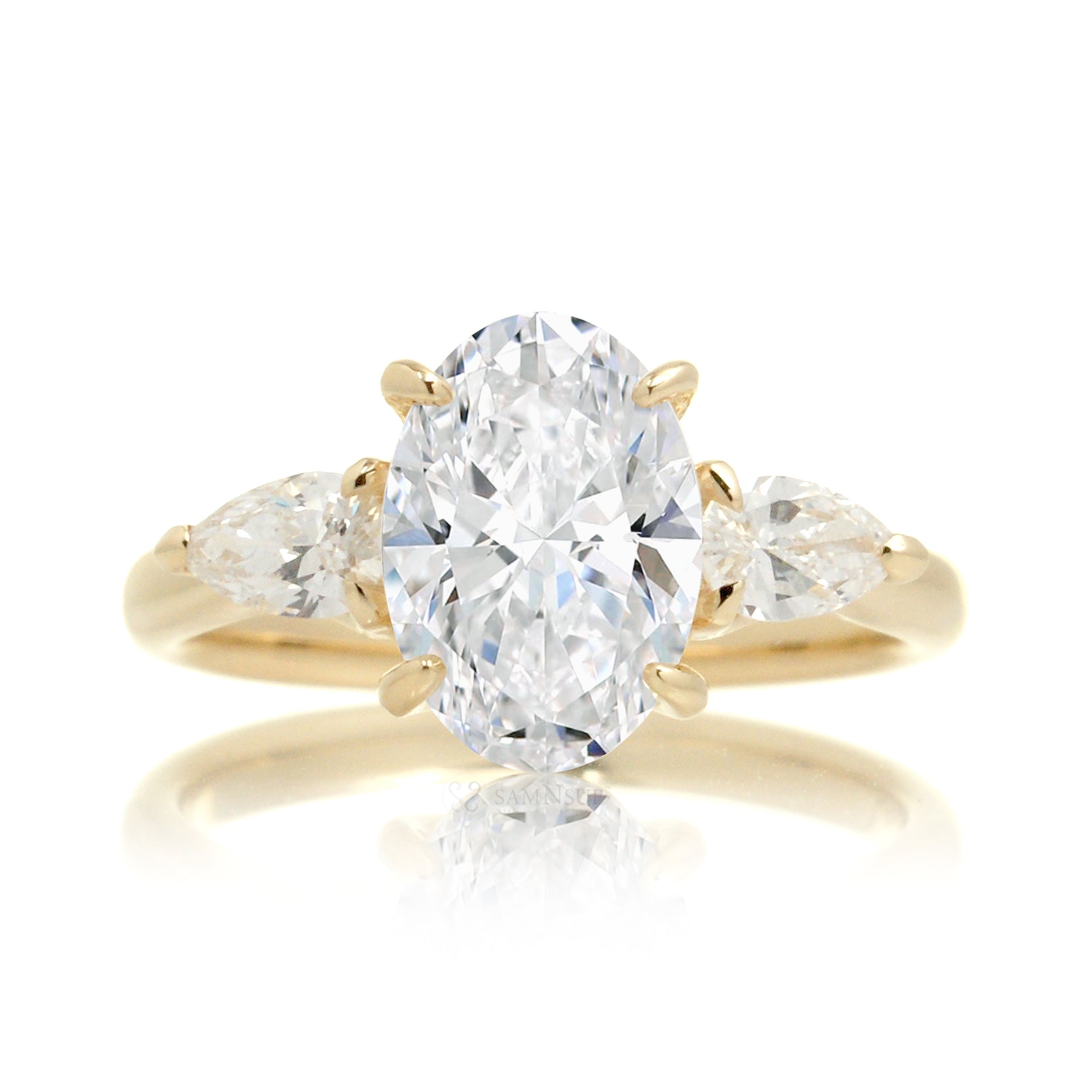 Classic three-stone oval cut diamond engagement ring yellow gold