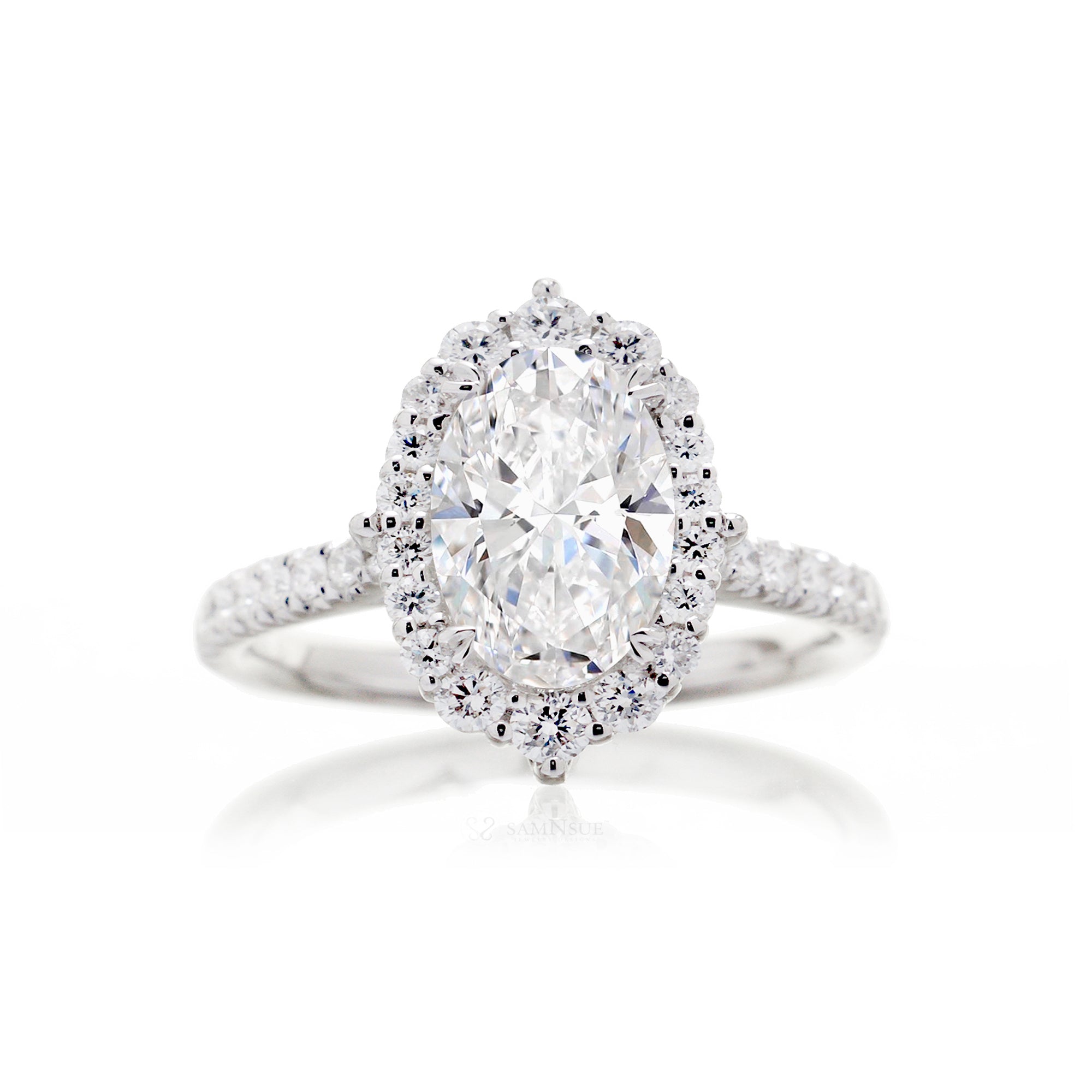 Oval diamond ring with halo and cathedral setting in white gold