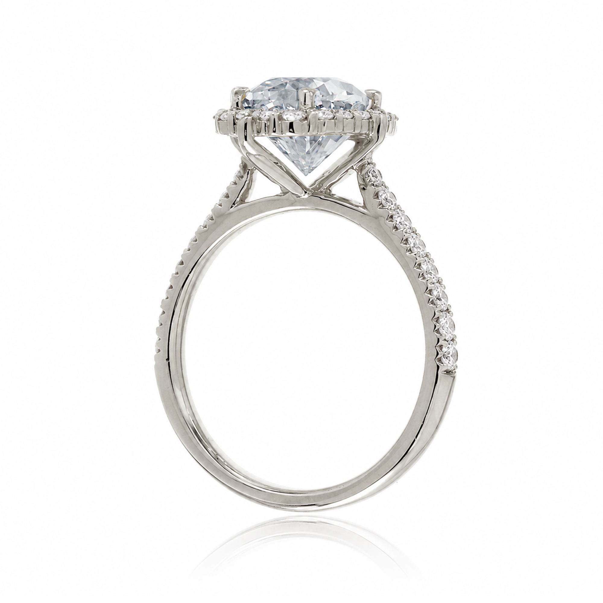 Oval diamond ring with halo and cathedral setting in white gold