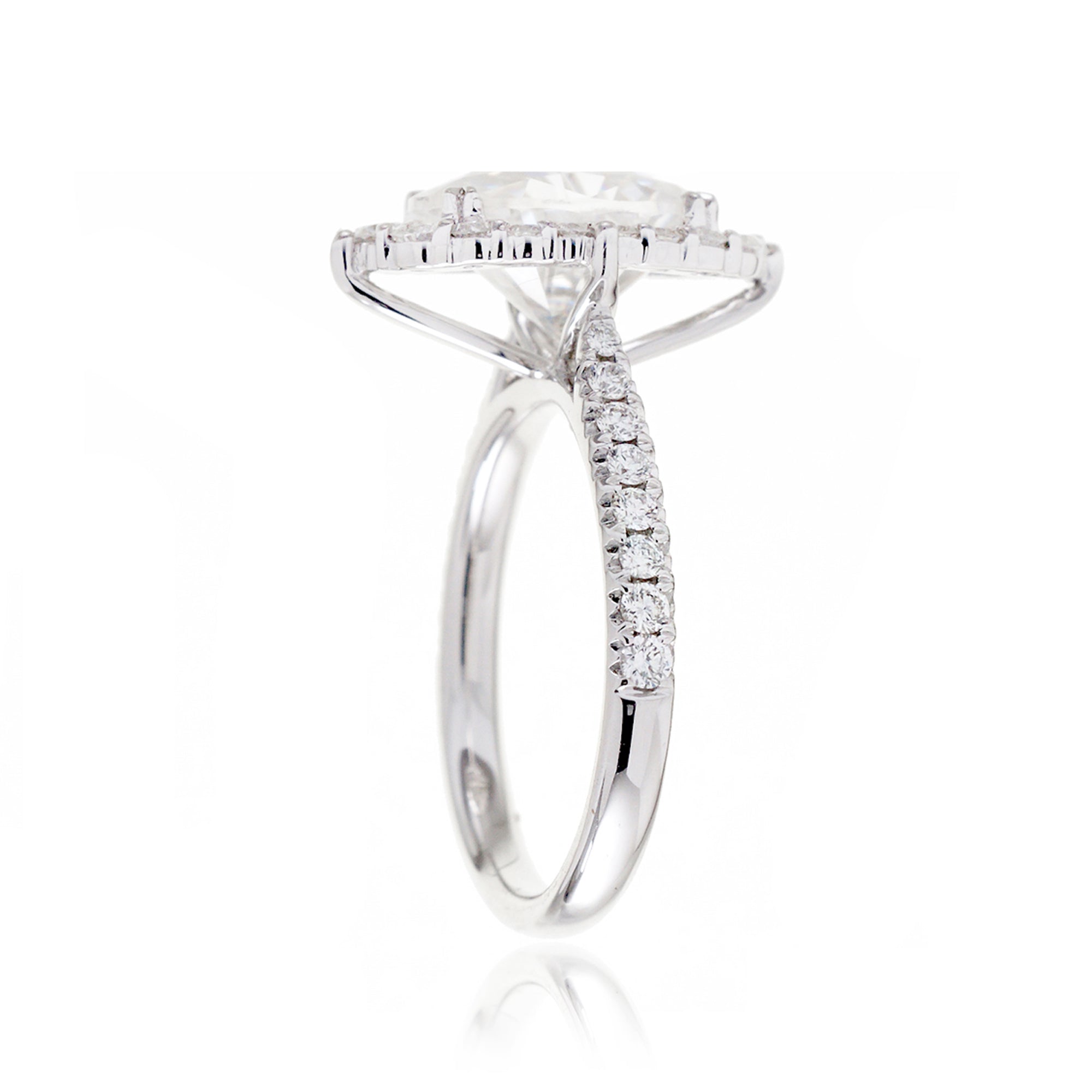 Oval diamond ring with halo and cathedral setting in white gold