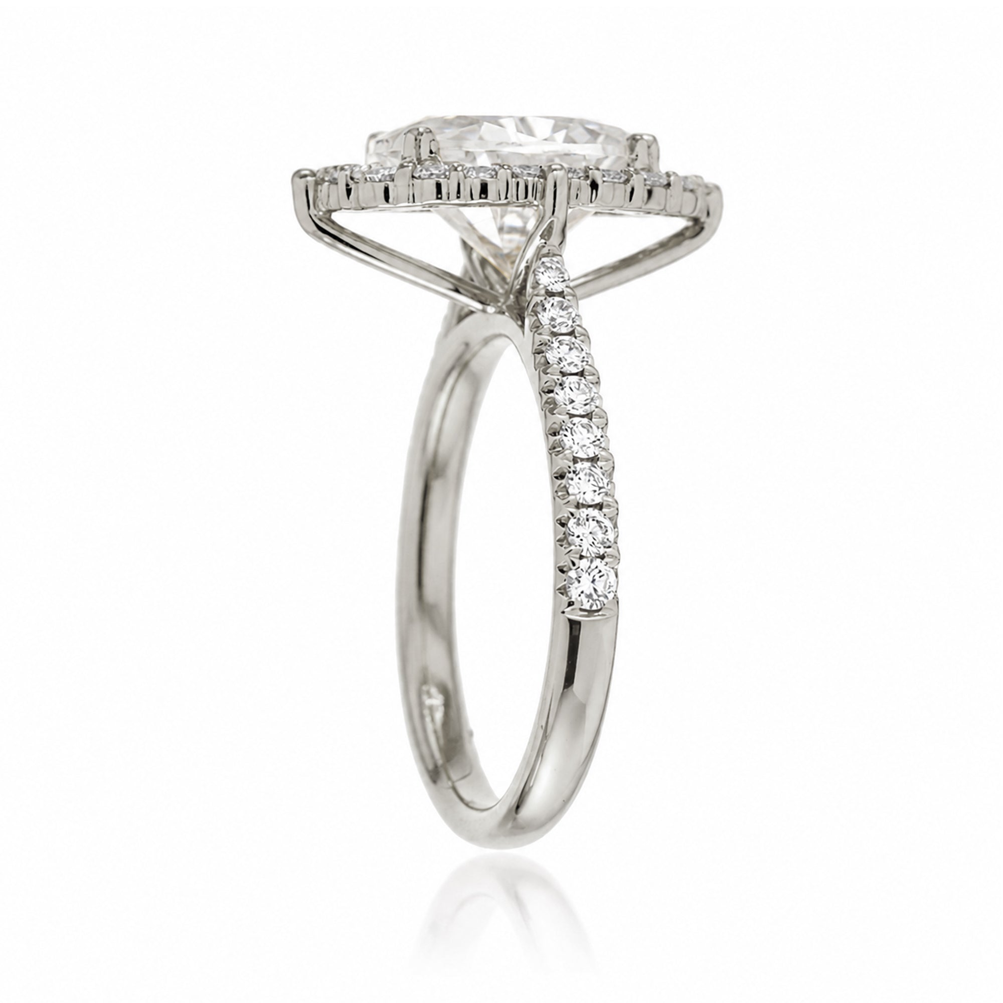 Oval diamond ring with halo and cathedral setting in white gold