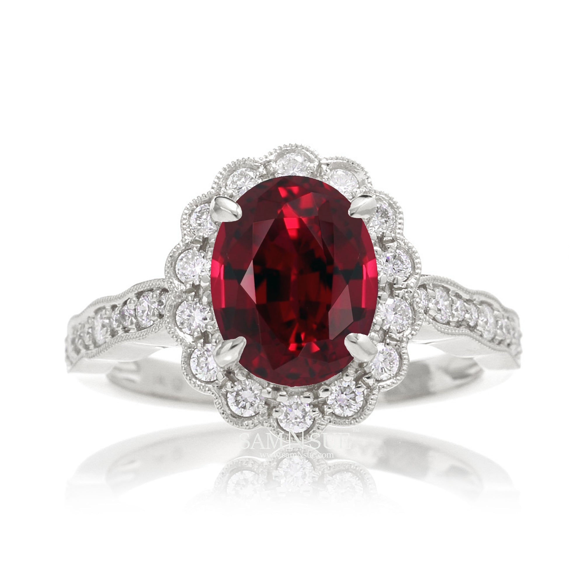 Oval cut ruby and diamond engagement ring with a vintage scallop band and halo white gold