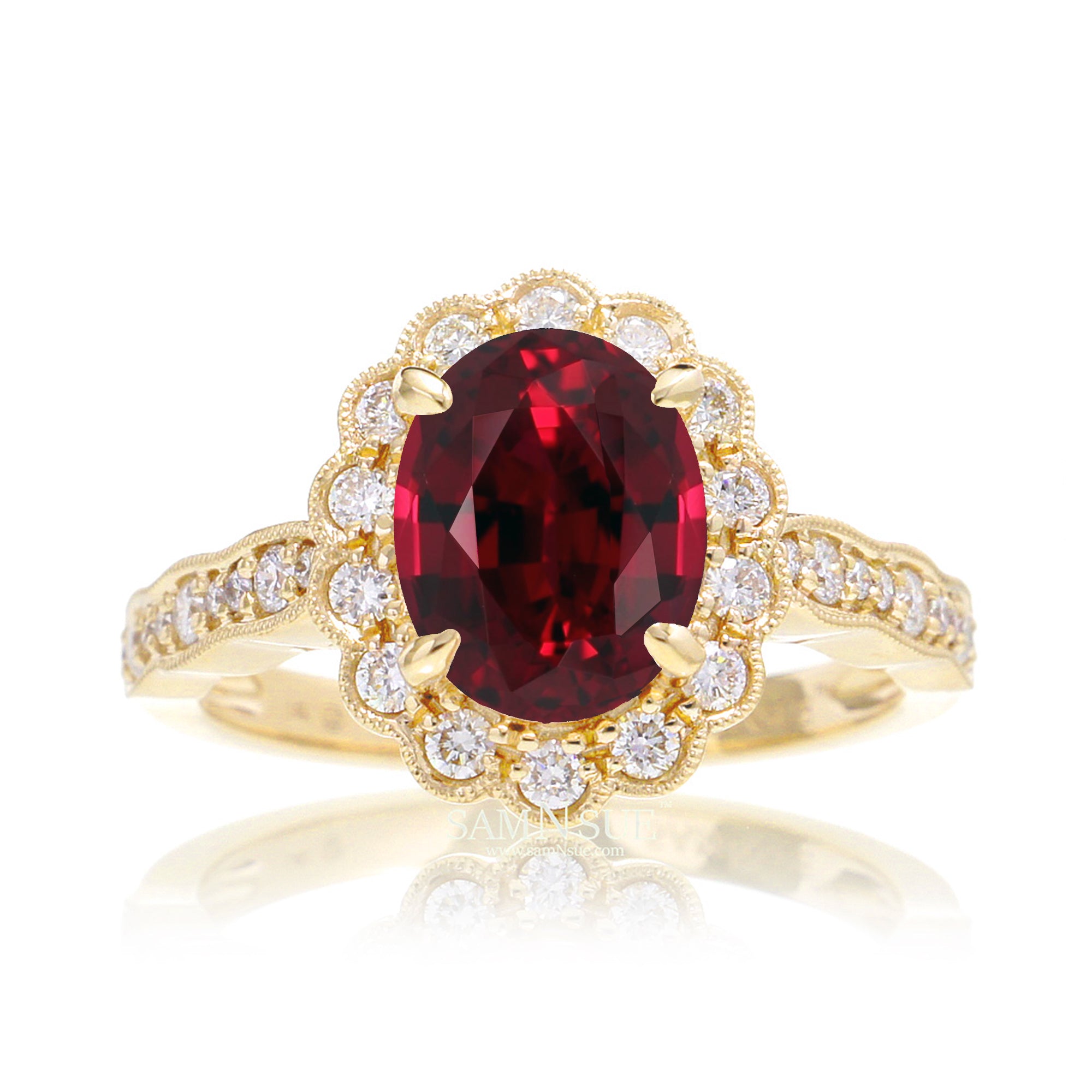 Oval cut ruby and diamond engagement ring with a vintage scallop band and halo yellow gold