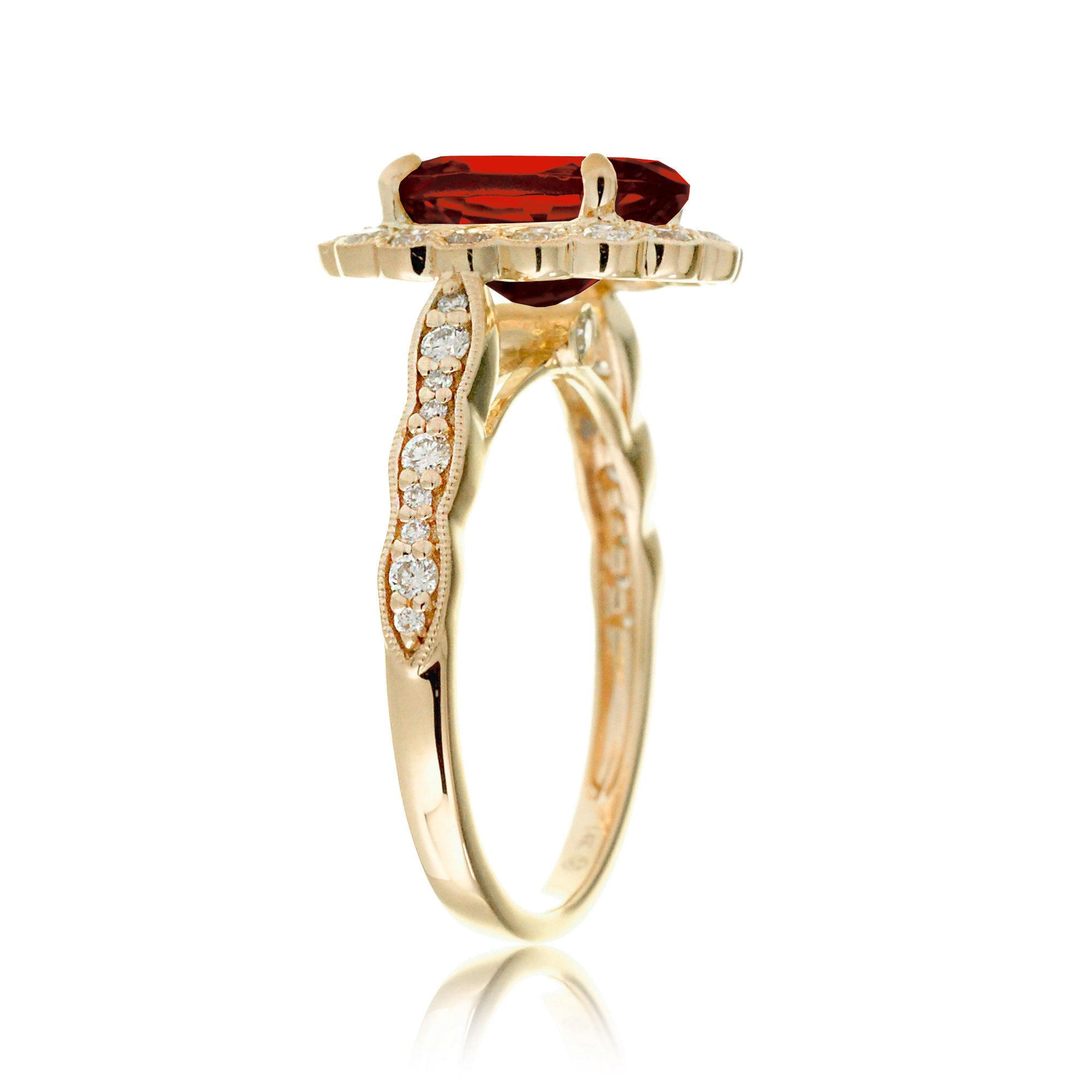 Oval cut ruby and diamond engagement ring with a vintage scallop band and halo yellow gold