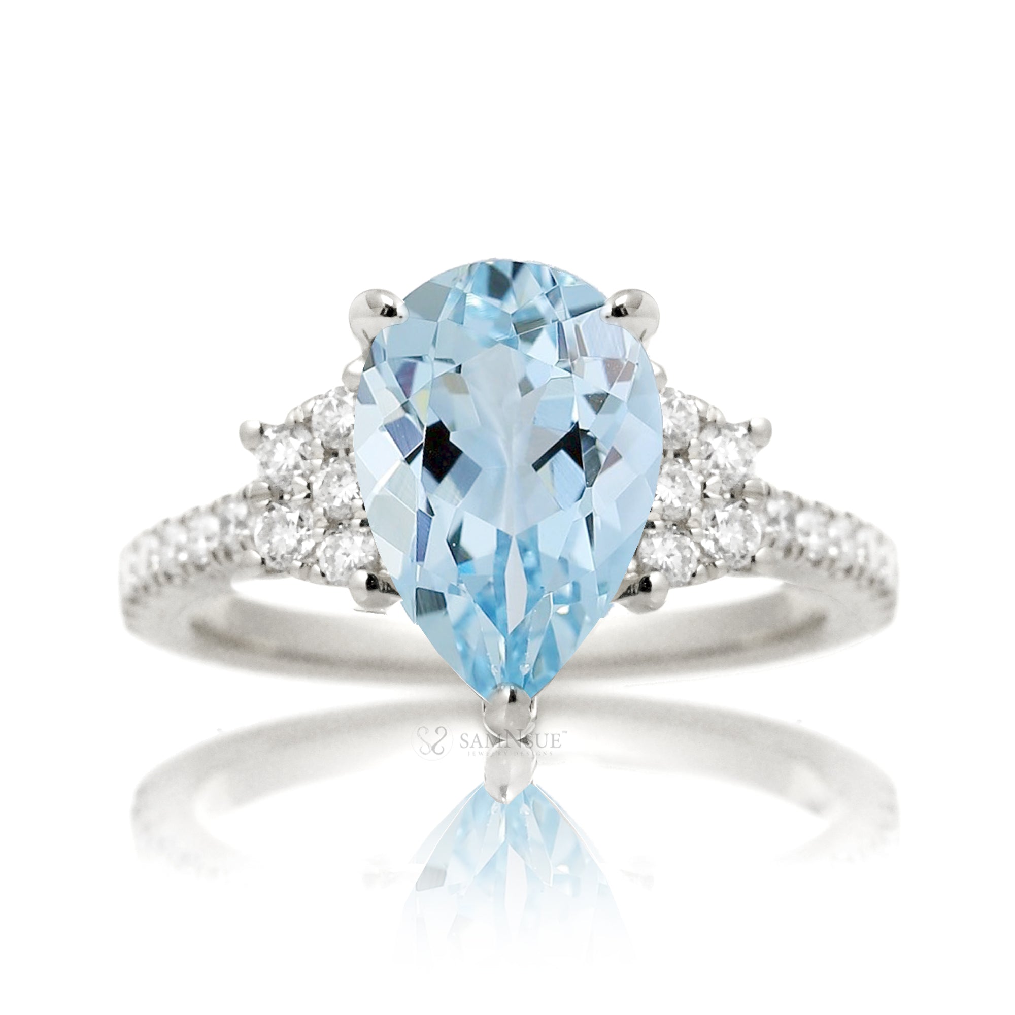 Pear aquamarine with diamond accent on the band and trapezoid shape side stones white gold