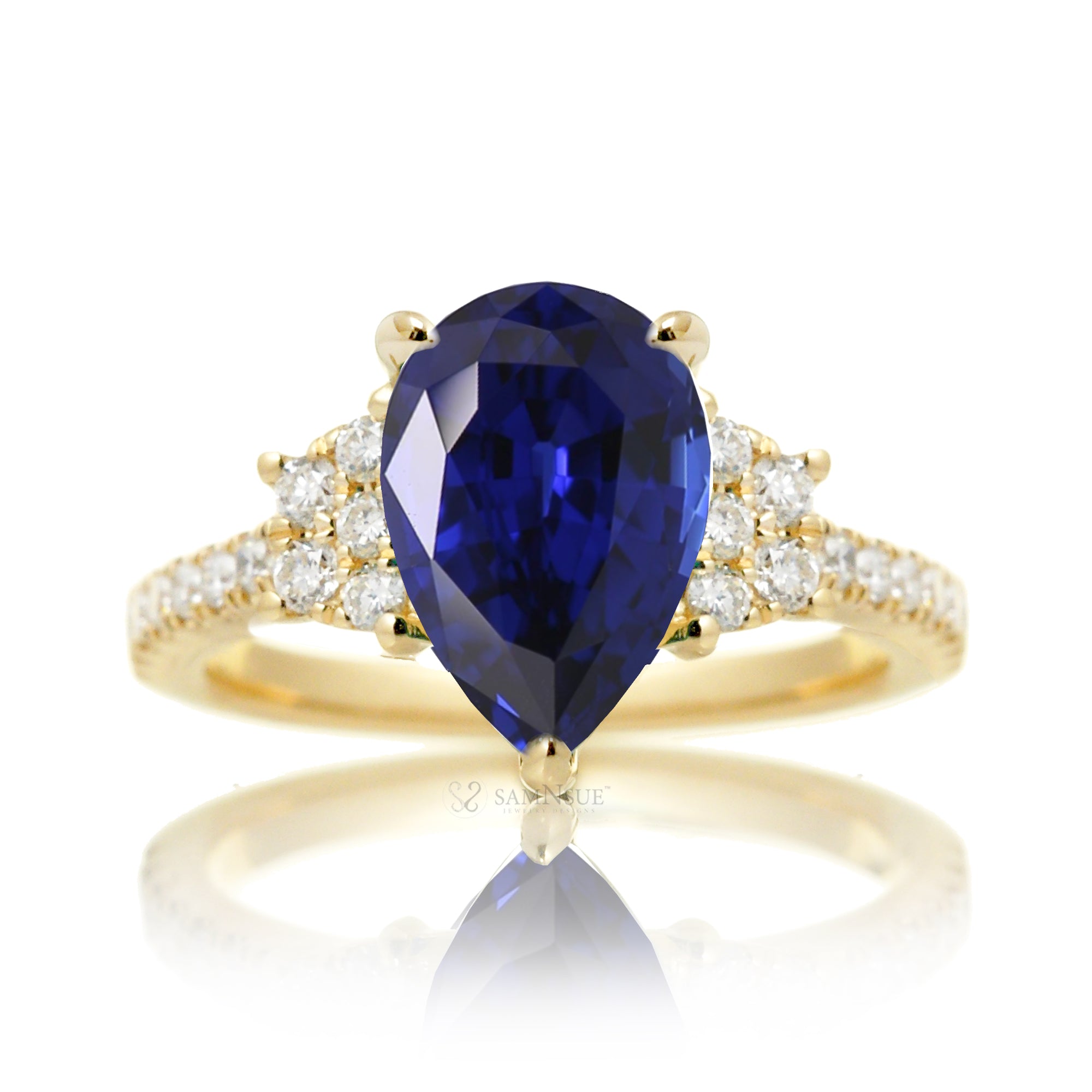 Pear blue sapphire and diamond band engagement ring in yellow gold