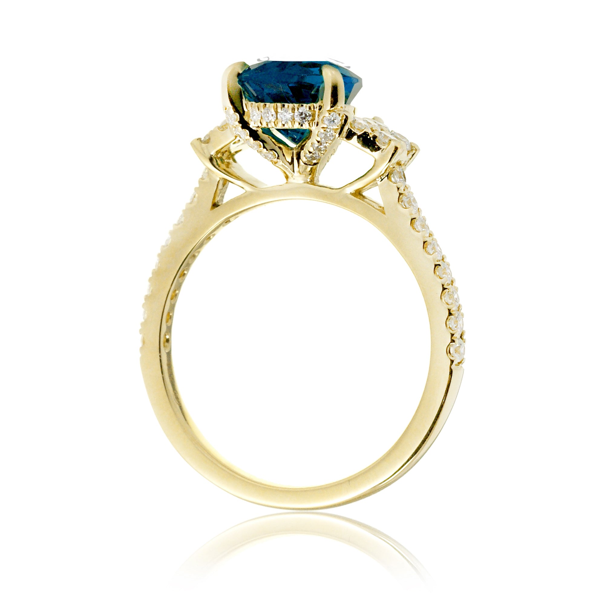 Pear blue sapphire and diamond band engagement ring in yellow gold