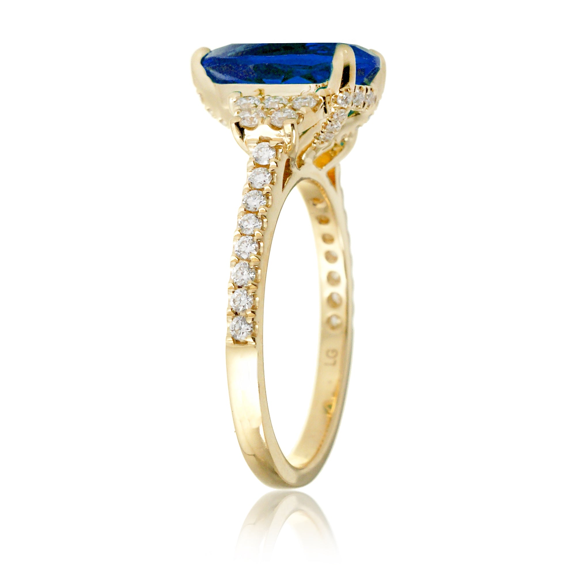 Pear blue sapphire and diamond band engagement ring in yellow gold
