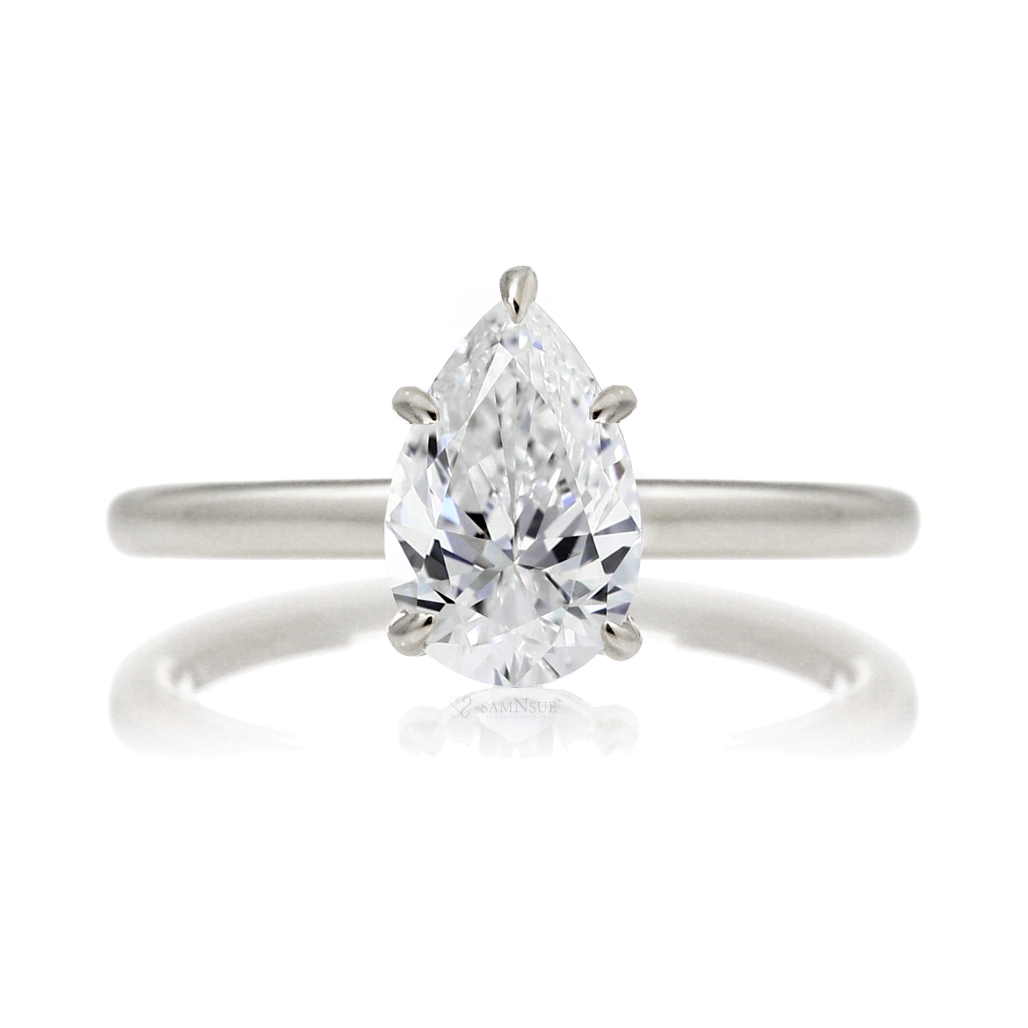 Pear cut solitaire diamond engagement ring with a hidden halo and solid polished band in white gold