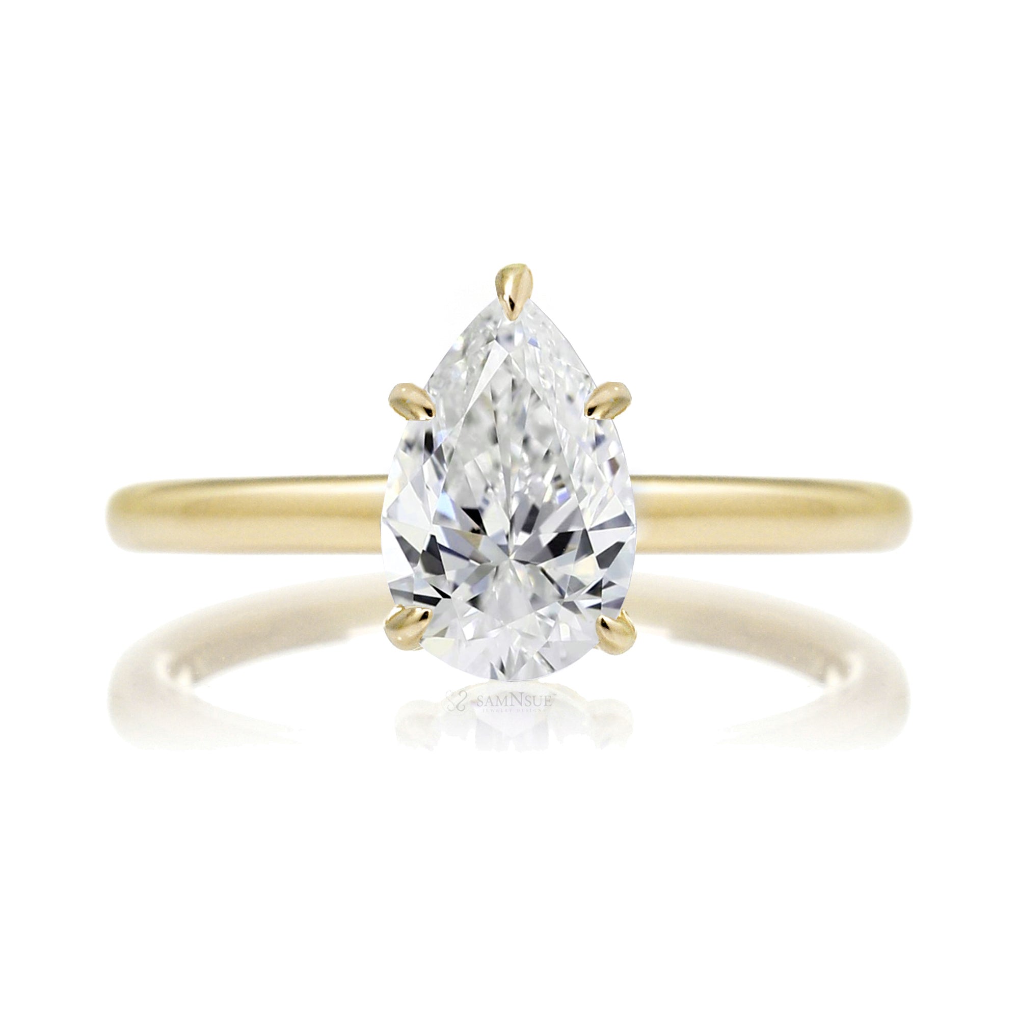 Pear cut solitaire diamond engagement ring with a hidden halo and solid polished band in yellow gold