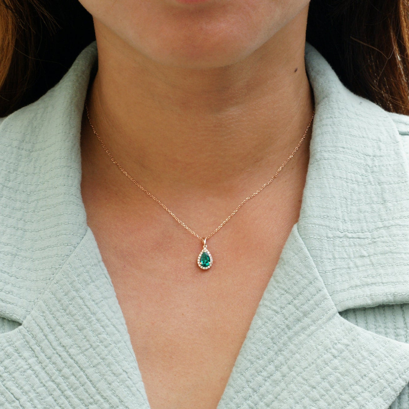 Pear green emerald pendant with diamond halo rose gold