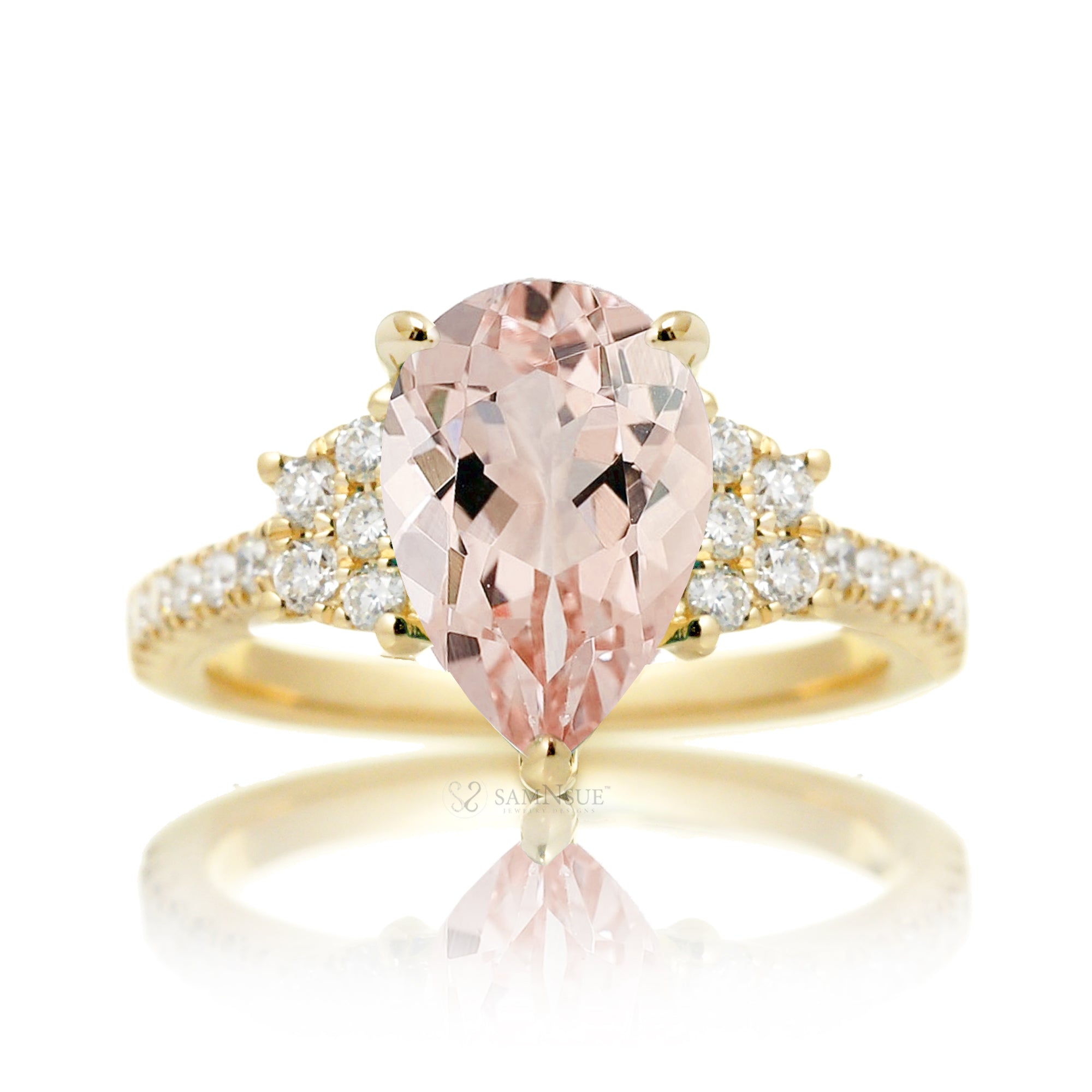 Pear morganite engagement ring with diamond accent in a trapezoid shape in yellow gold