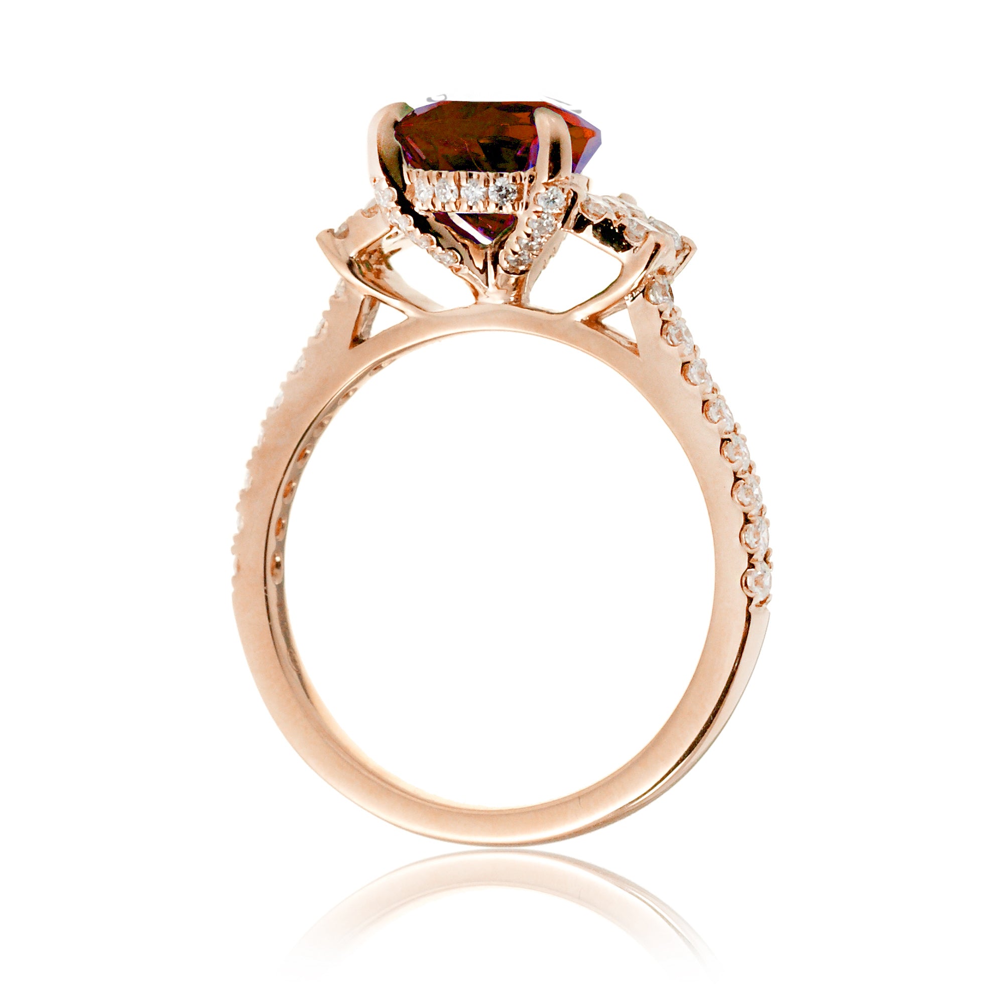 Pear cut ruby ring with trapezoid diamond side shape and band in rose gold