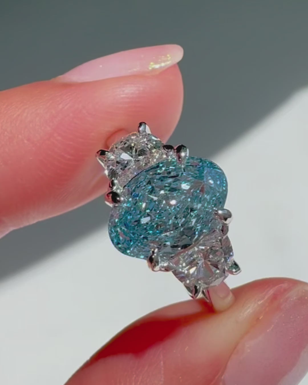 2ct oval blue diamond ring with half moon stones