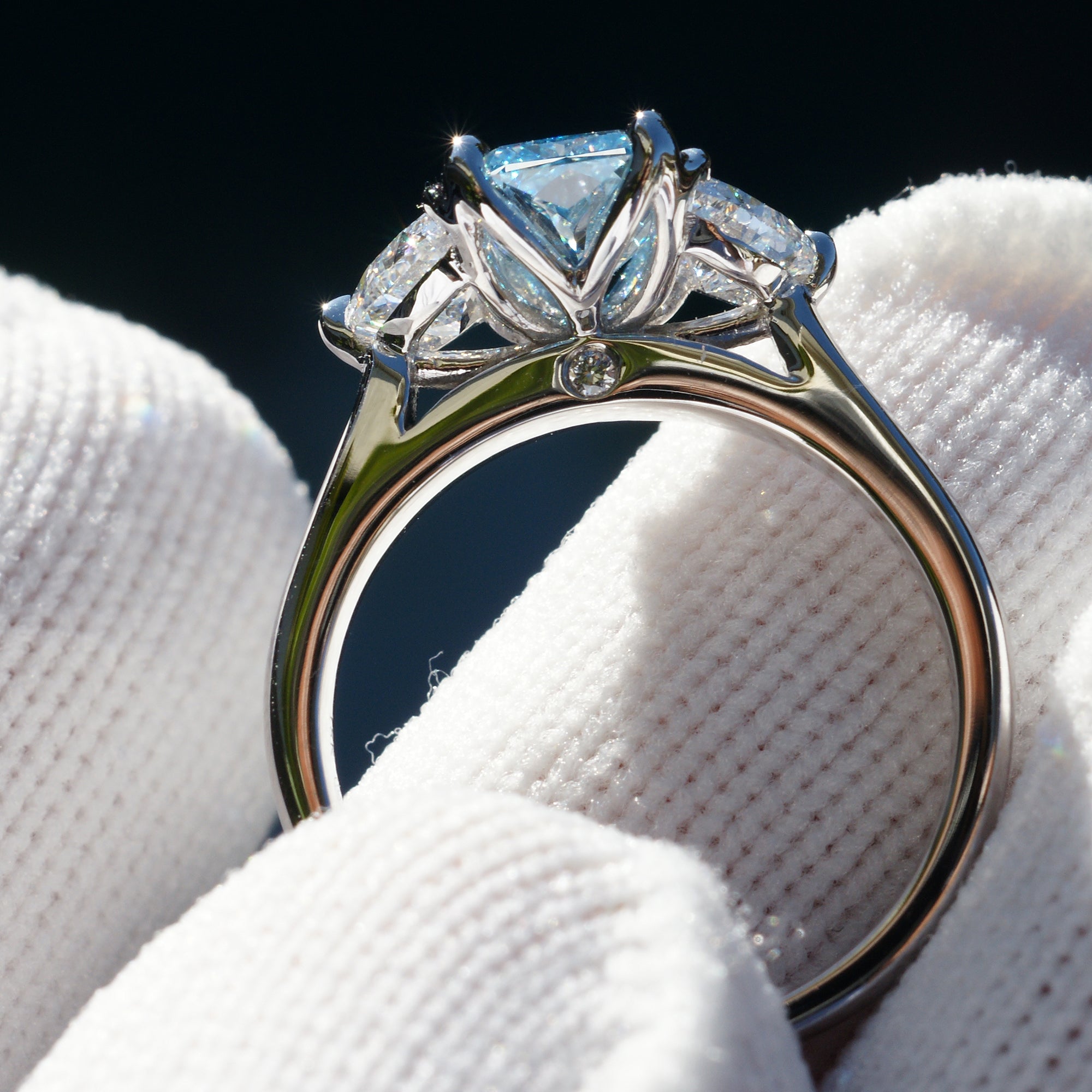 Rare fancy blue radiant cut diamond half moon three stone ring
