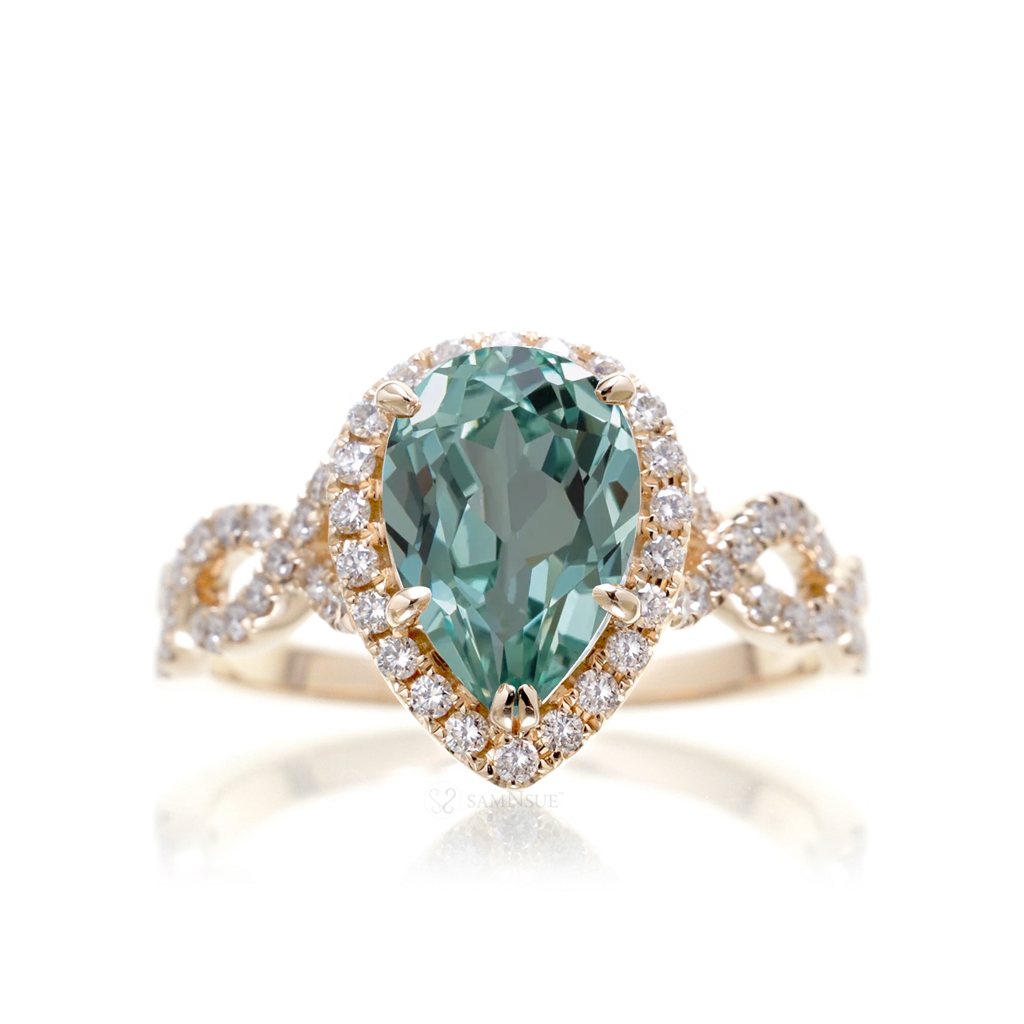 Twist band diamond halo ring with pear green sapphire yellow gold