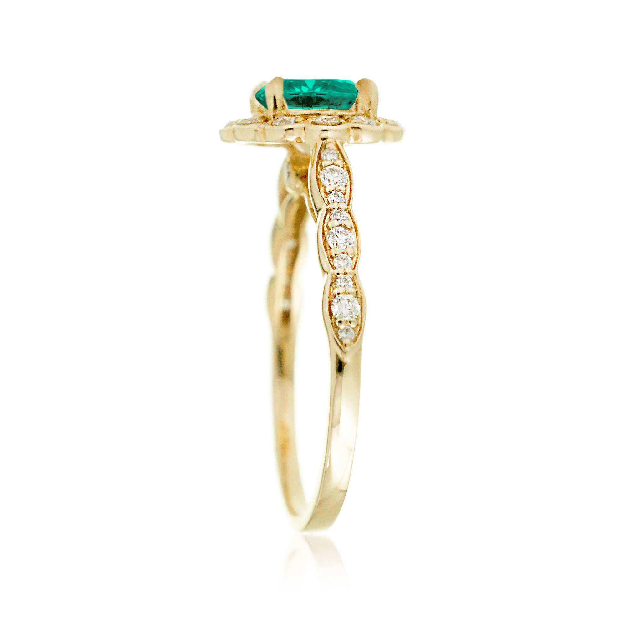 Round emerald engagement ring with scallop halo in yellow gold