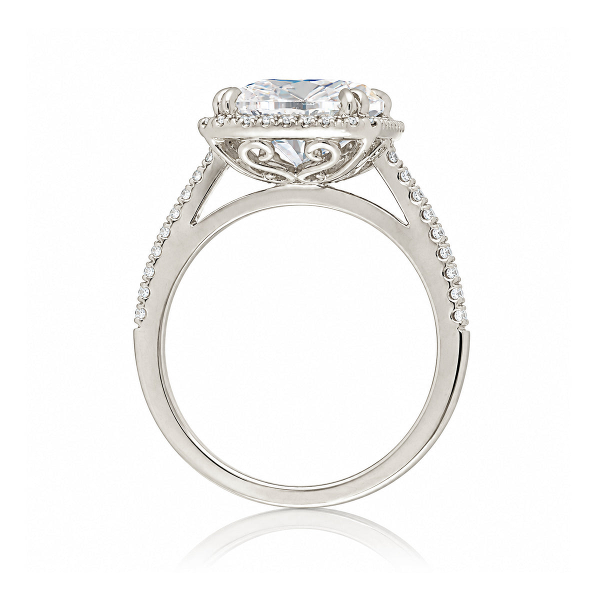 Emerald step cut diamond halo ring with a squarish band and cathedral setting white gold