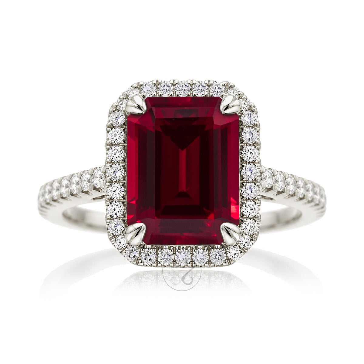 Emerald step cut ruby halo ring with a squarish band and cathedral setting white gold
