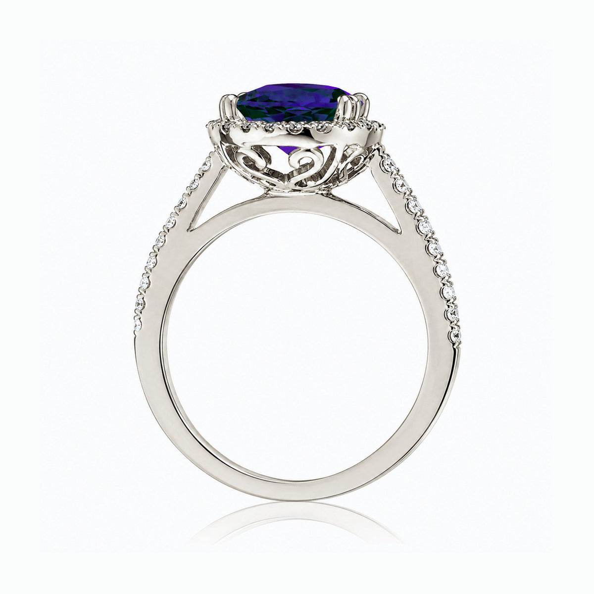 Oval blue sapphire engagement ring with diamond halo and square diamond band on a cathedral white gold setting