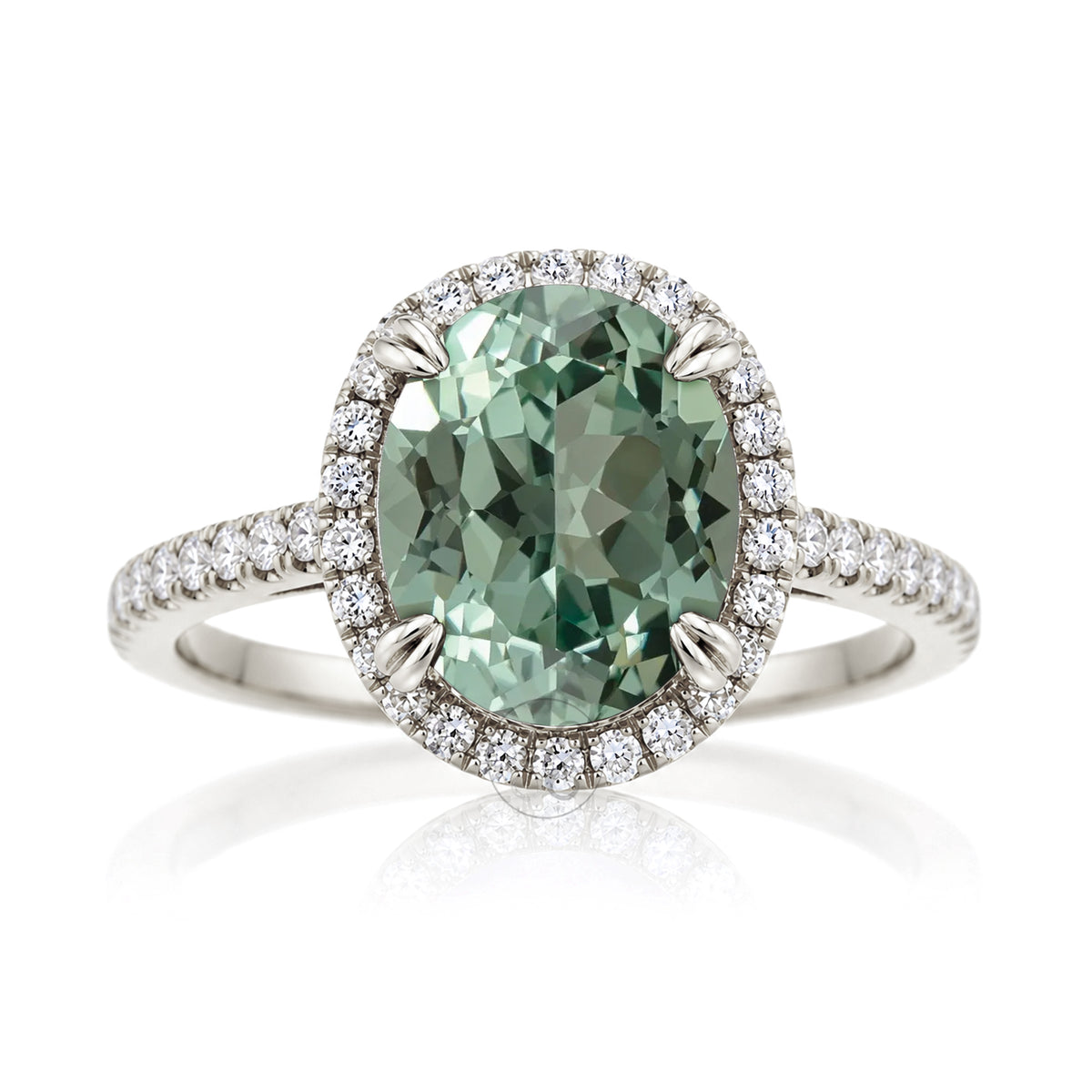 Oval green sapphire engagement ring with diamond halo in white gold