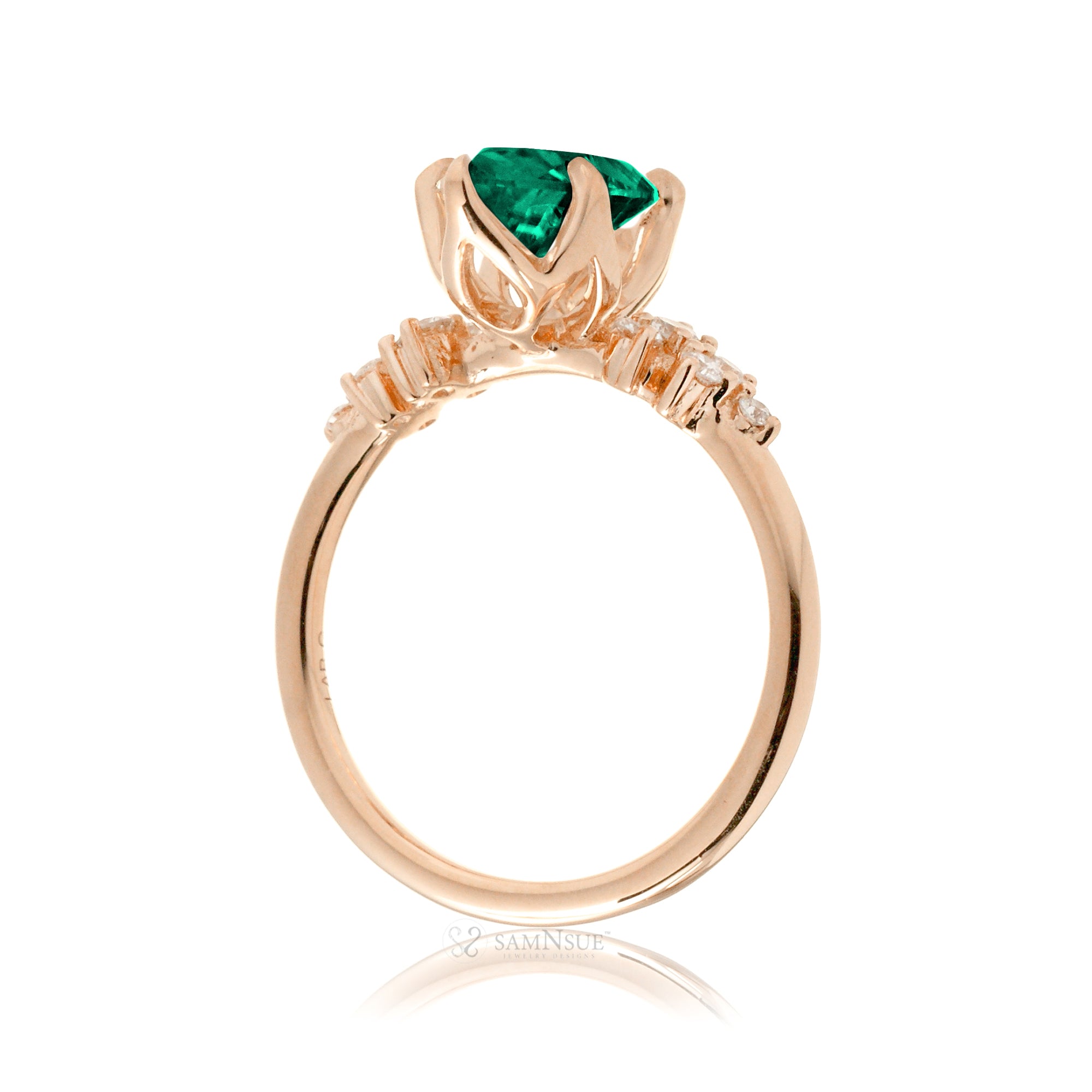 Oval emerald ring with diamond accent on rose gold
