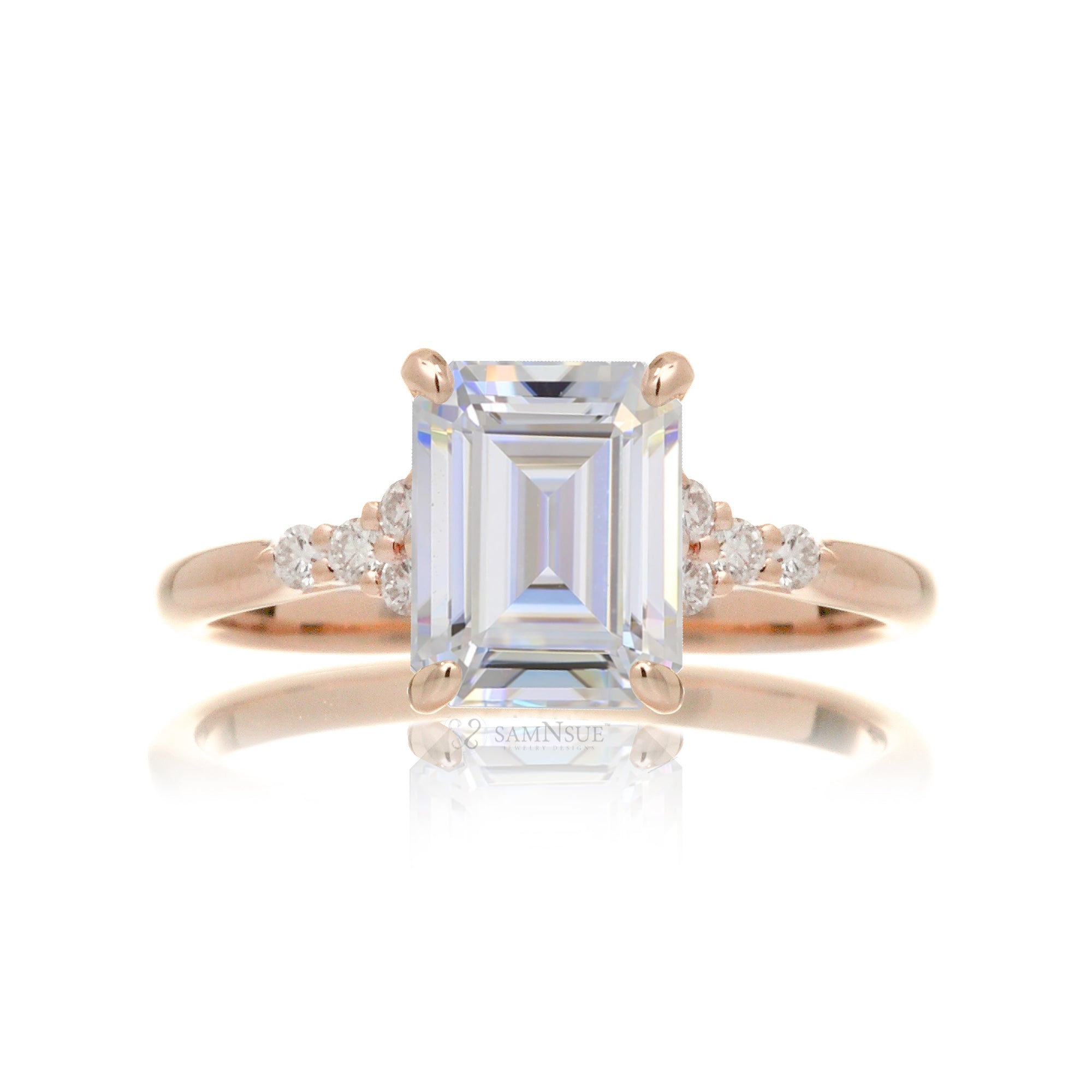 Emerald cut moissanite three stone diamond ring in rose gold