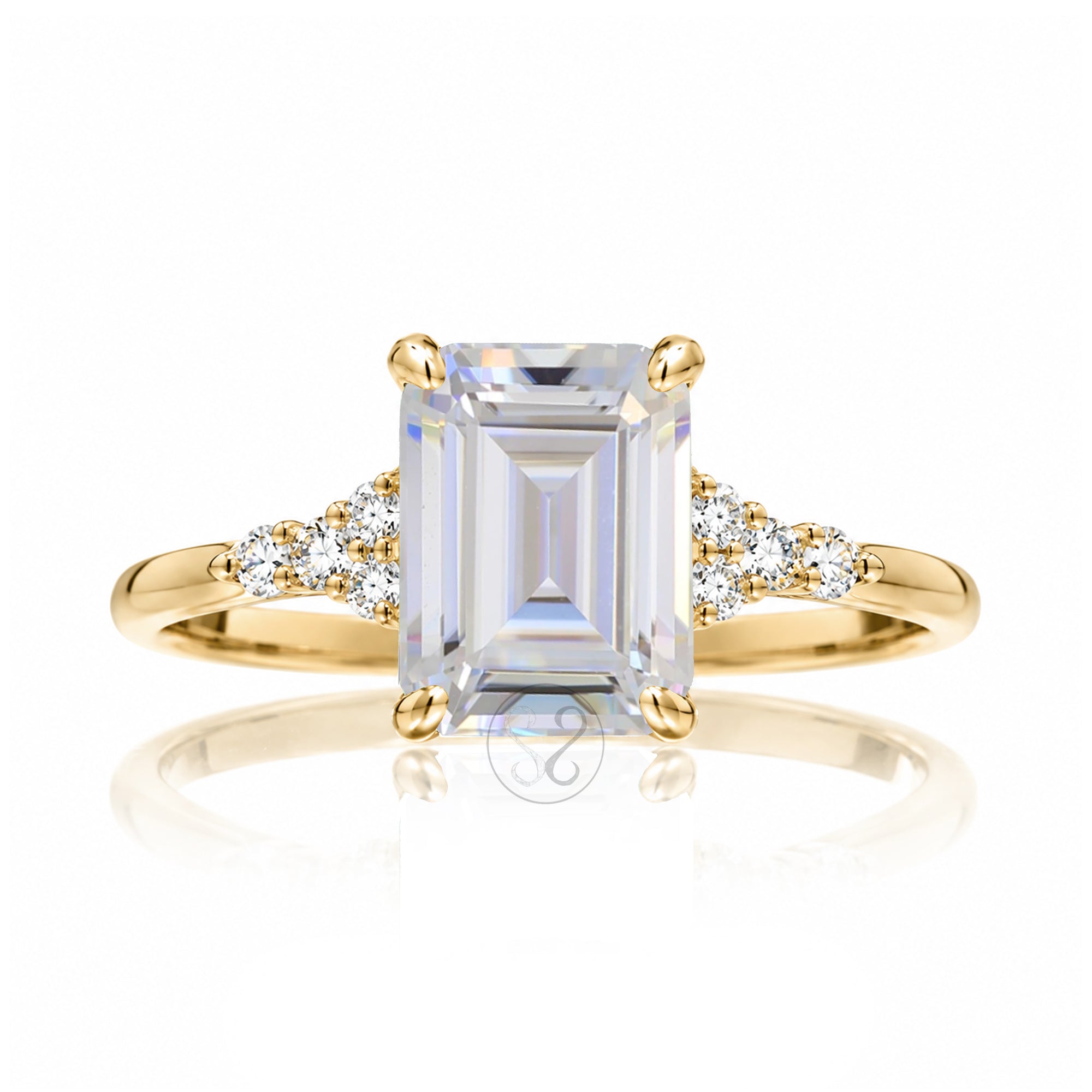 Emerald cut moissanite three stone diamond ring in yellow gold