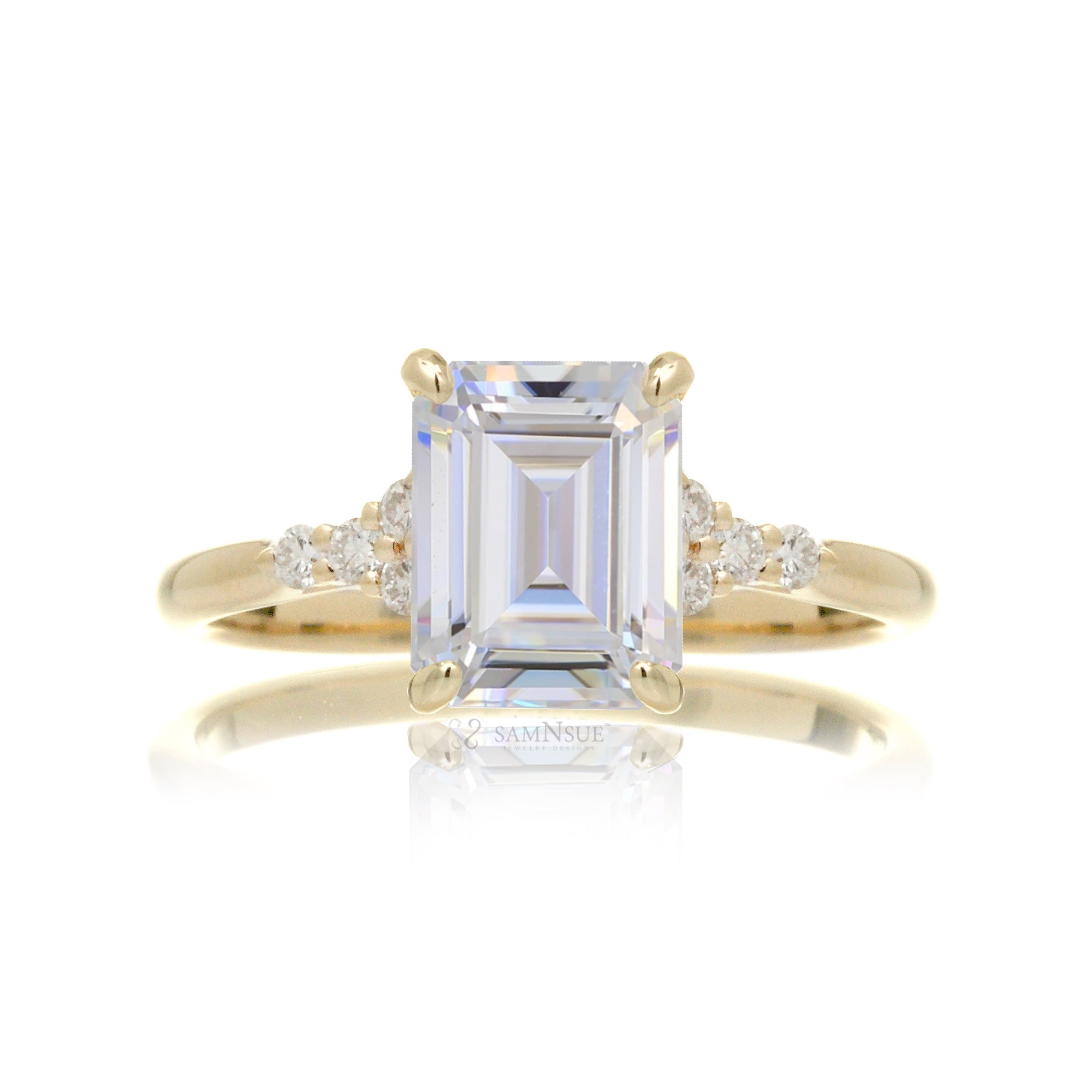 Emerald cut moissanite three stone diamond ring in yellow gold