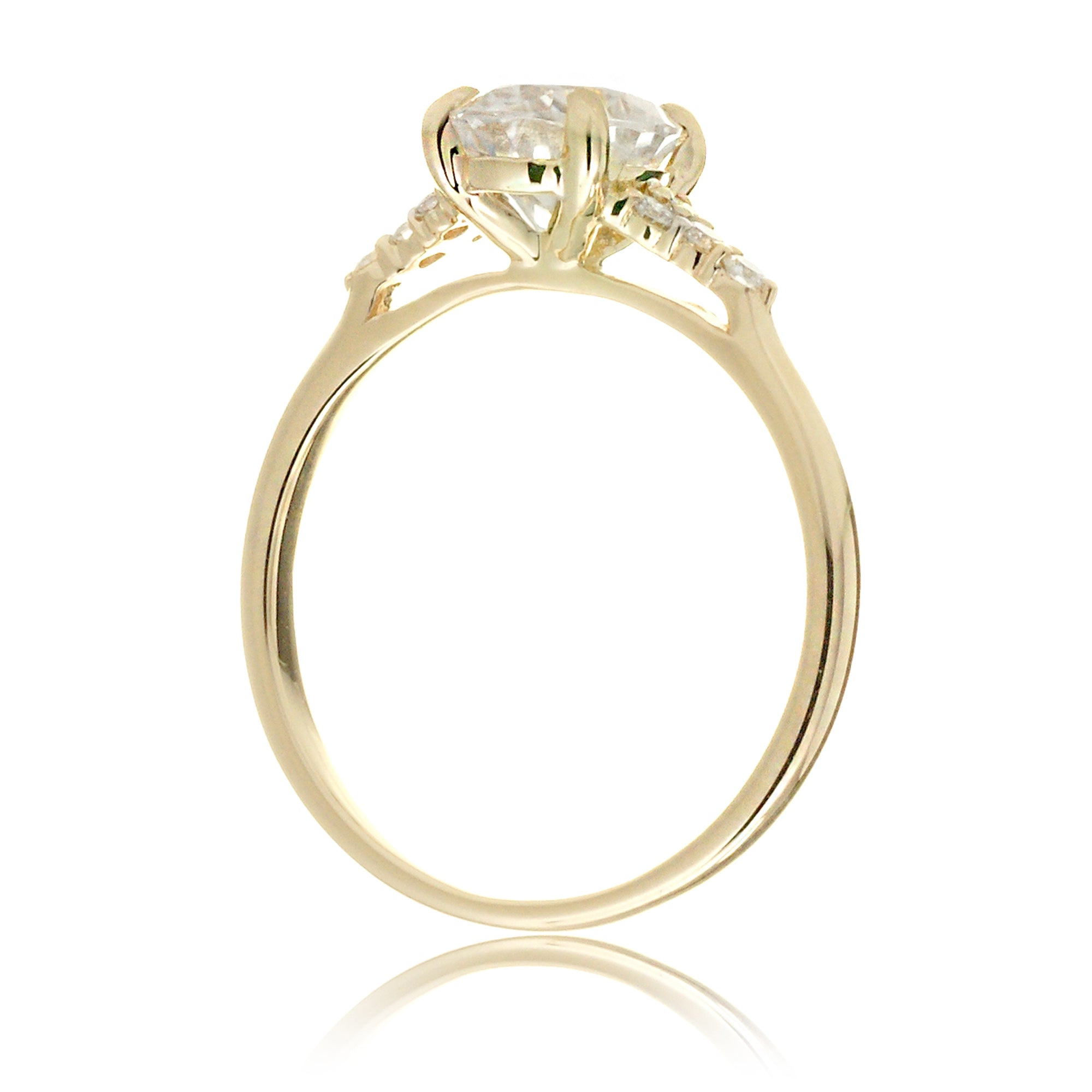 Emerald cut moissanite three stone diamond ring in yellow gold