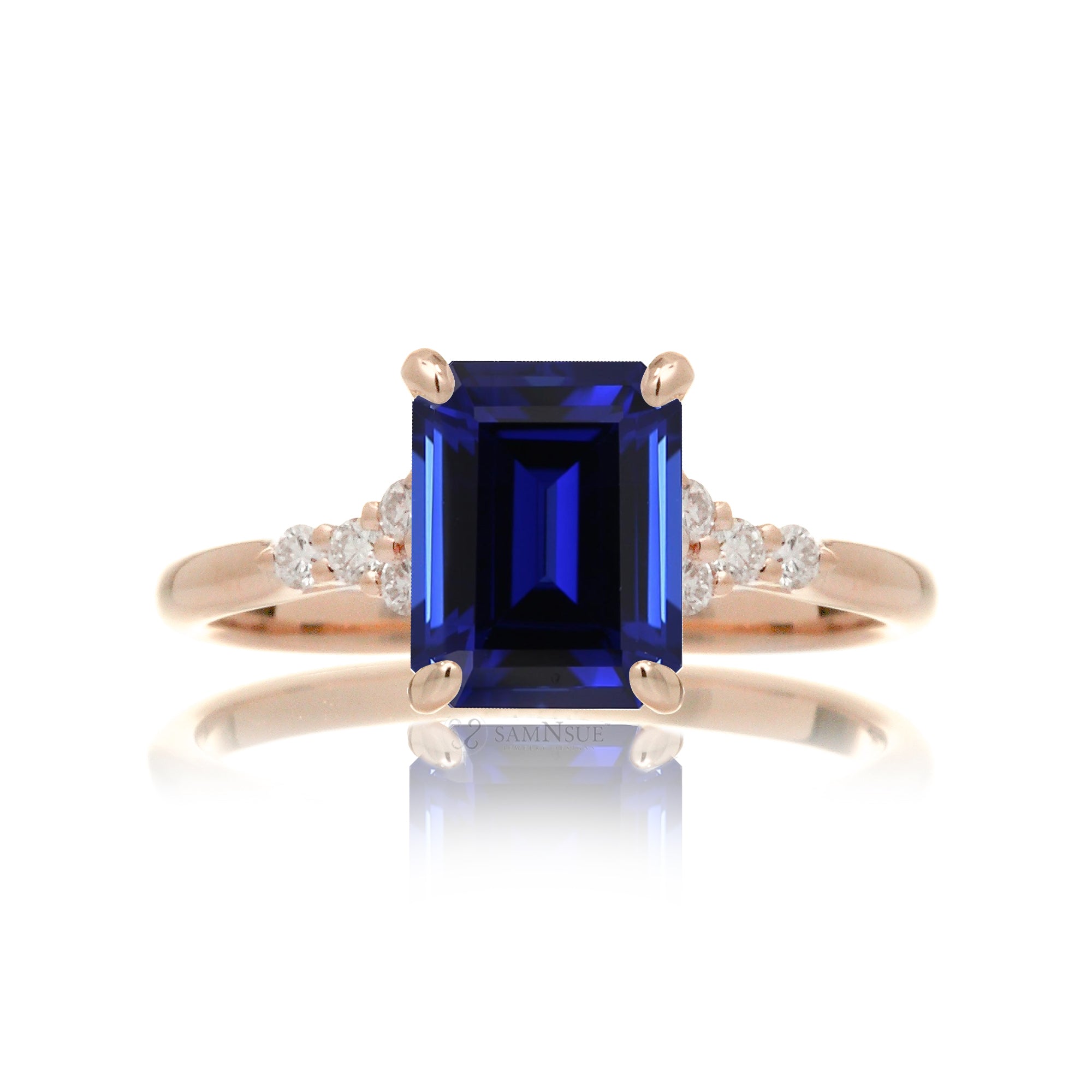 Sapphire engagement ring with a blue step emerald cut lab-grown sapphire and diamond accent in rose gold