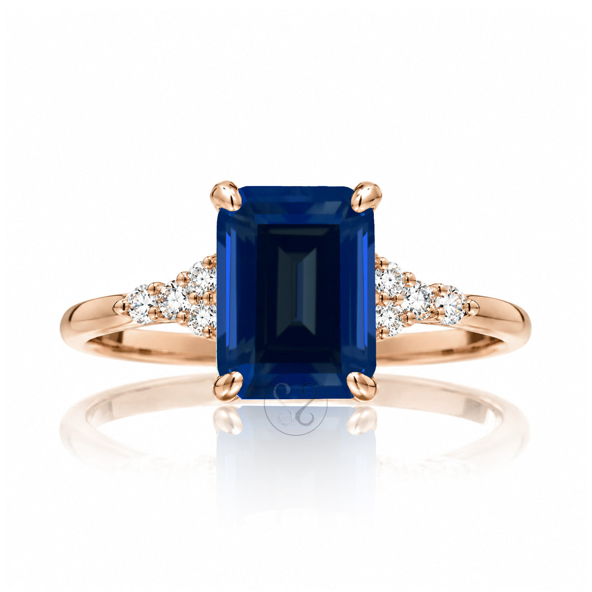 Sapphire engagement ring with a blue step emerald cut lab-grown sapphire and diamond accent in rose gold