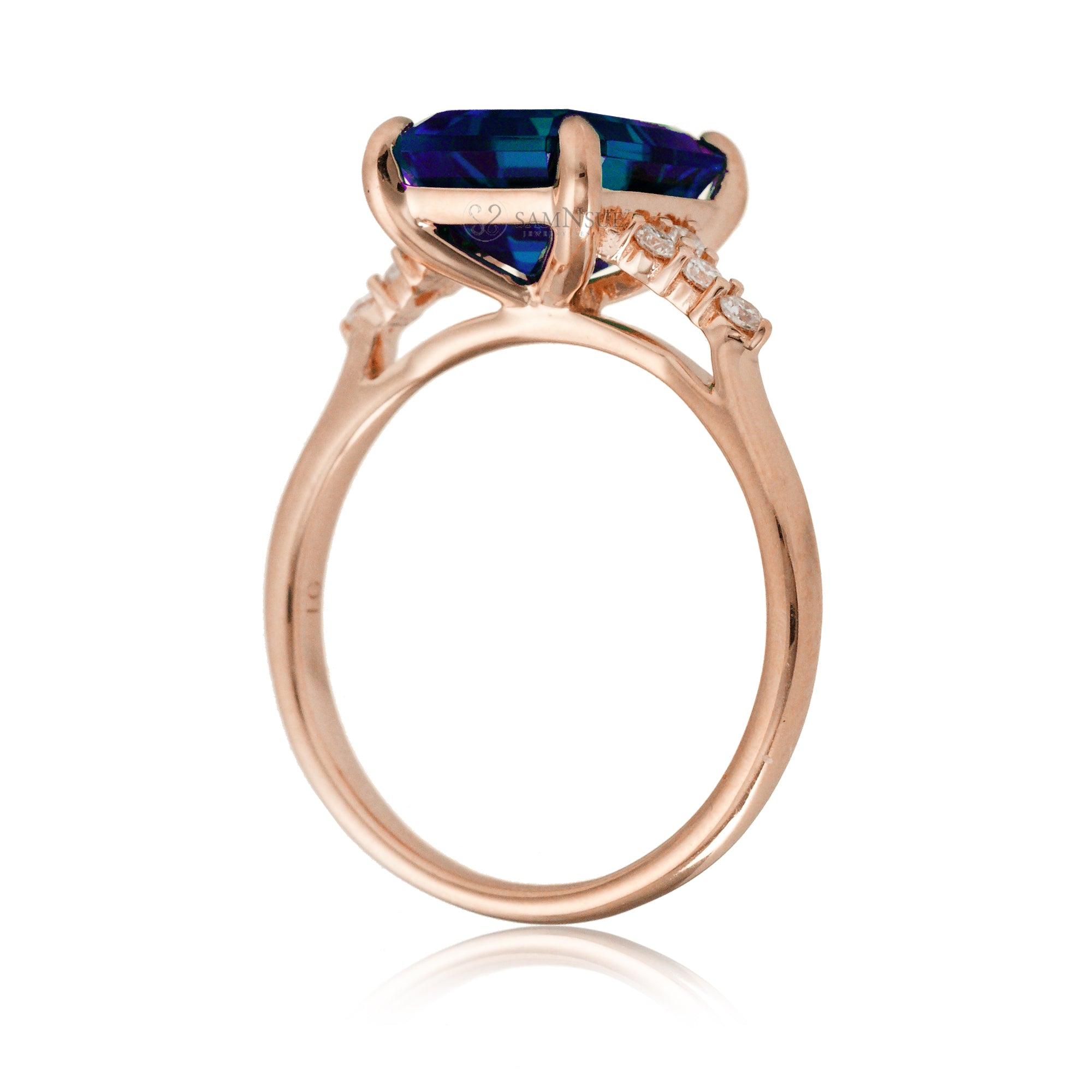 Sapphire engagement ring with a blue step emerald cut lab-grown sapphire and diamond accent in rose gold