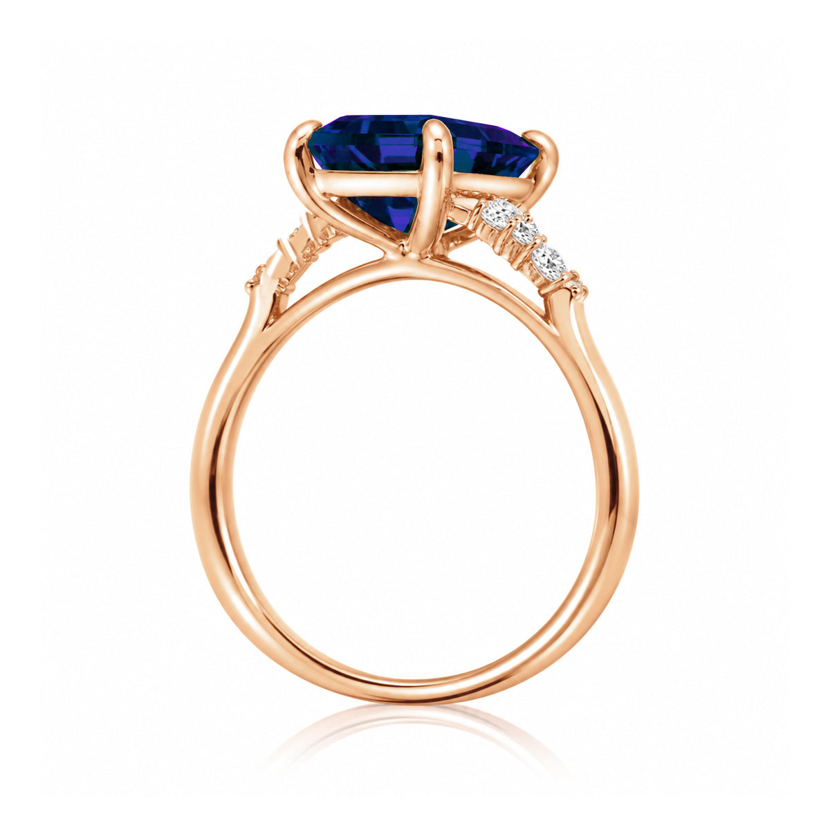 Sapphire engagement ring with a blue step emerald cut lab-grown sapphire and diamond accent in rose gold