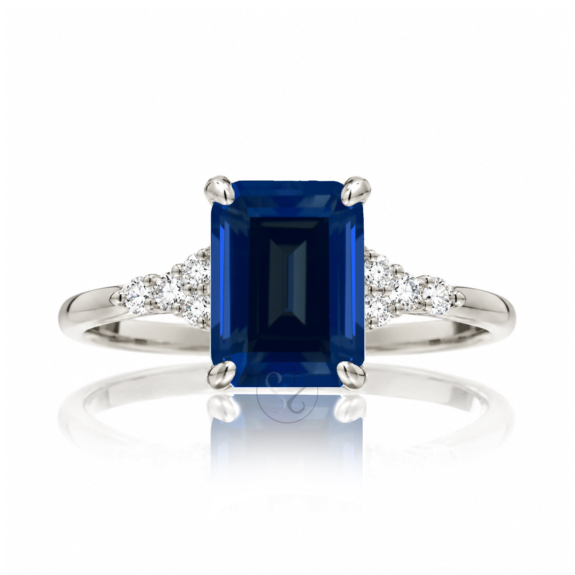 Sapphire engagement ring with a blue step emerald cut lab-grown sapphire and diamond accent in white gold