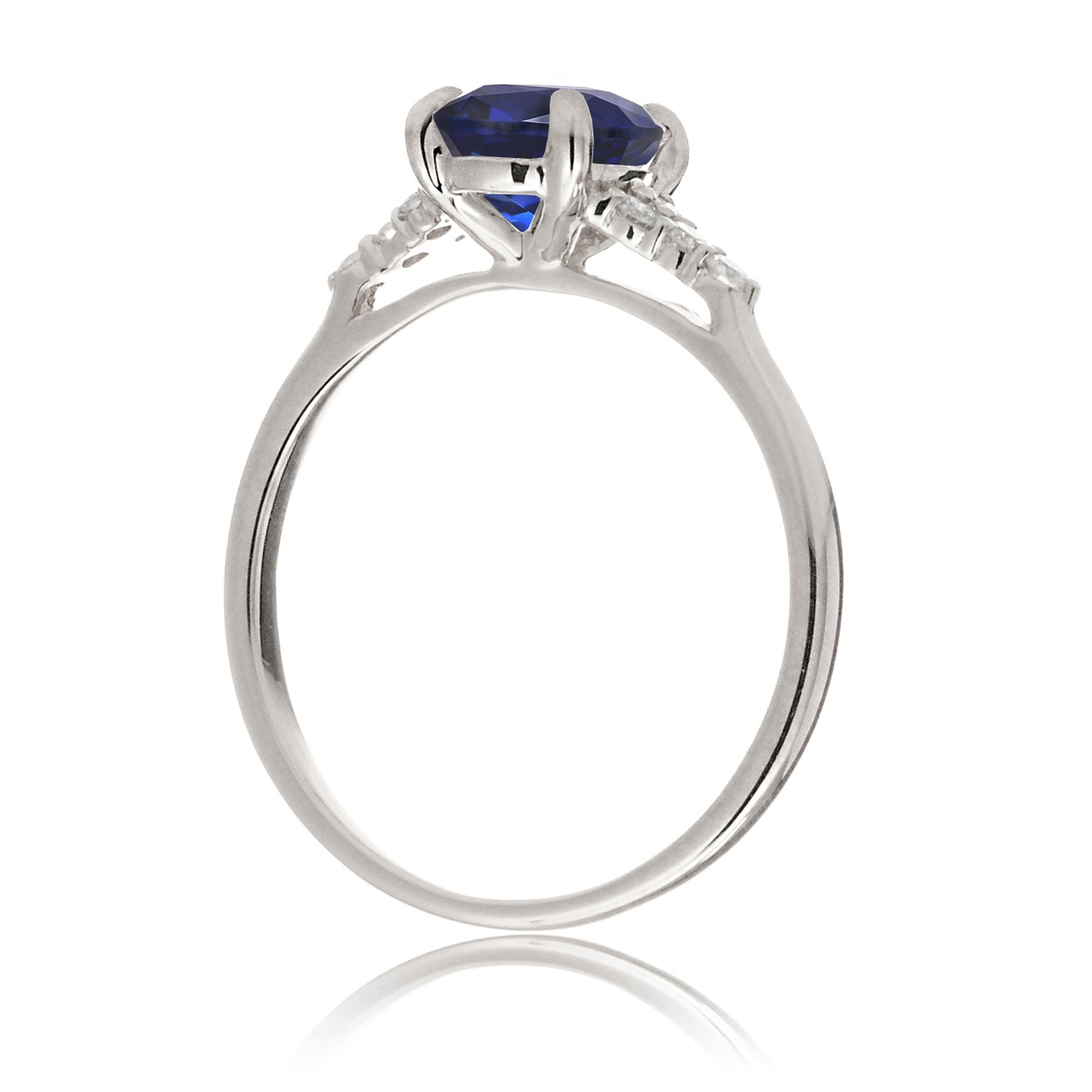 Sapphire engagement ring with a blue step emerald cut lab-grown sapphire and diamond accent in white gold