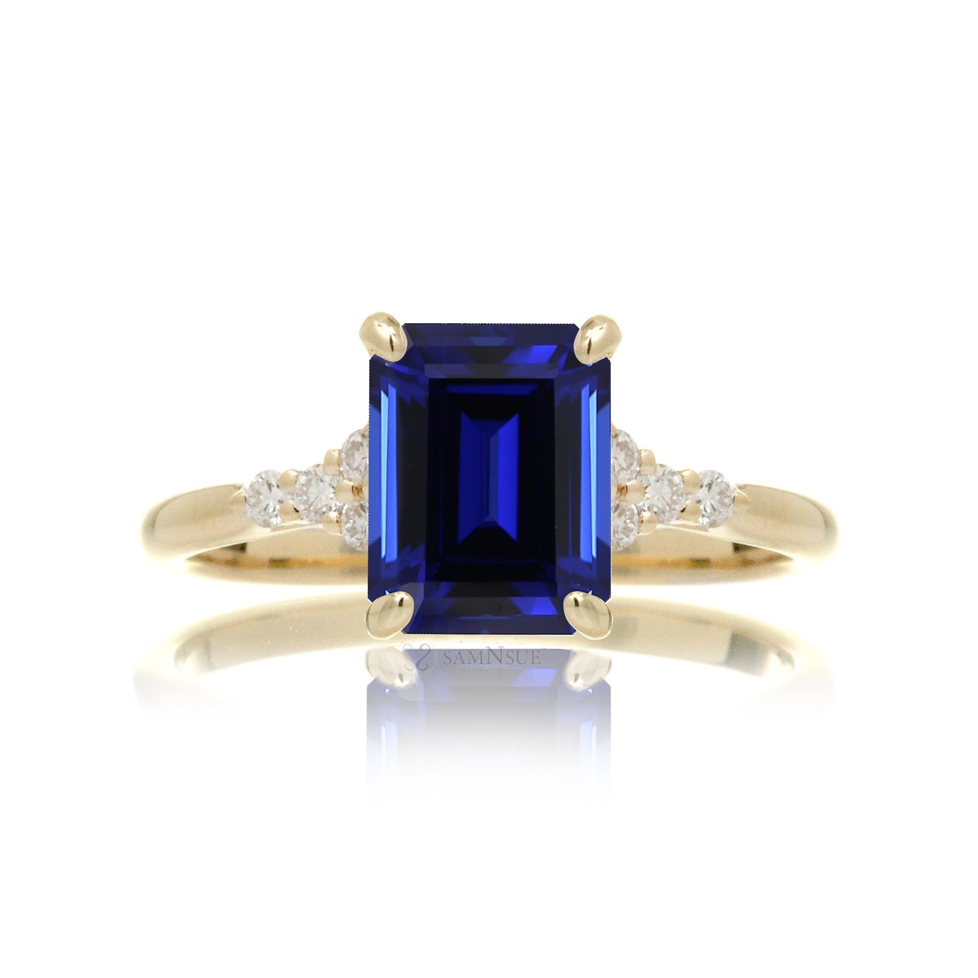Sapphire engagement ring with a blue step emerald cut lab-grown sapphire and diamond accent in yellow gold