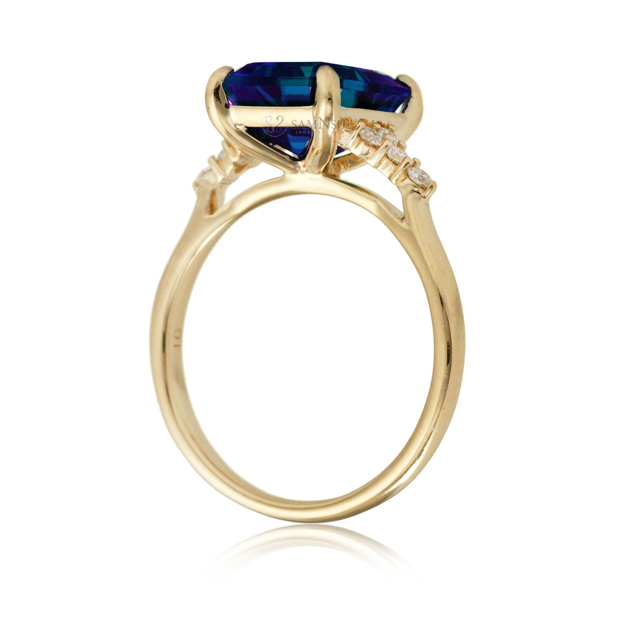 Sapphire engagement ring with a blue step emerald cut lab-grown sapphire and diamond accent in yellow gold