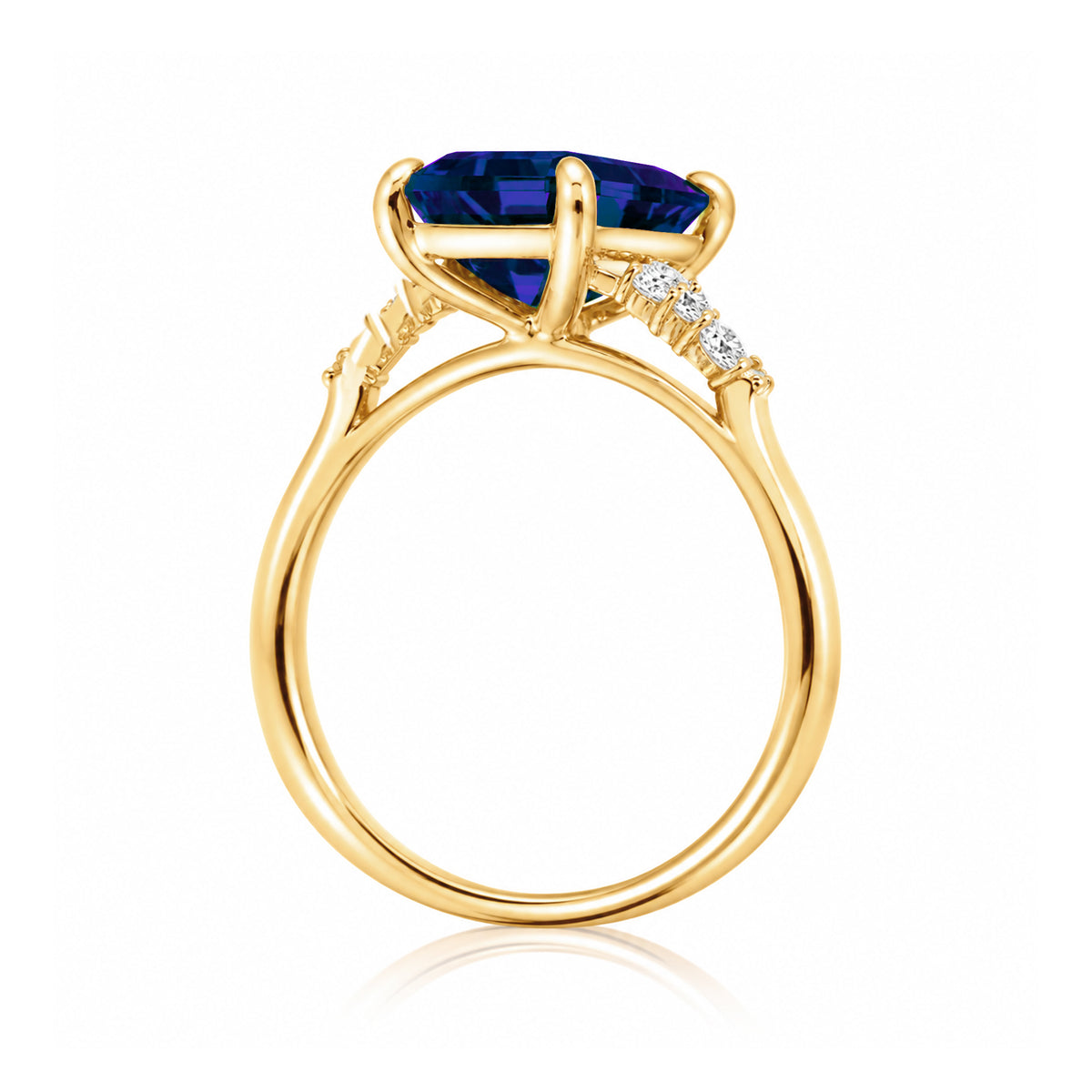 Sapphire engagement ring with a blue step emerald cut lab-grown sapphire and diamond accent in yellow gold