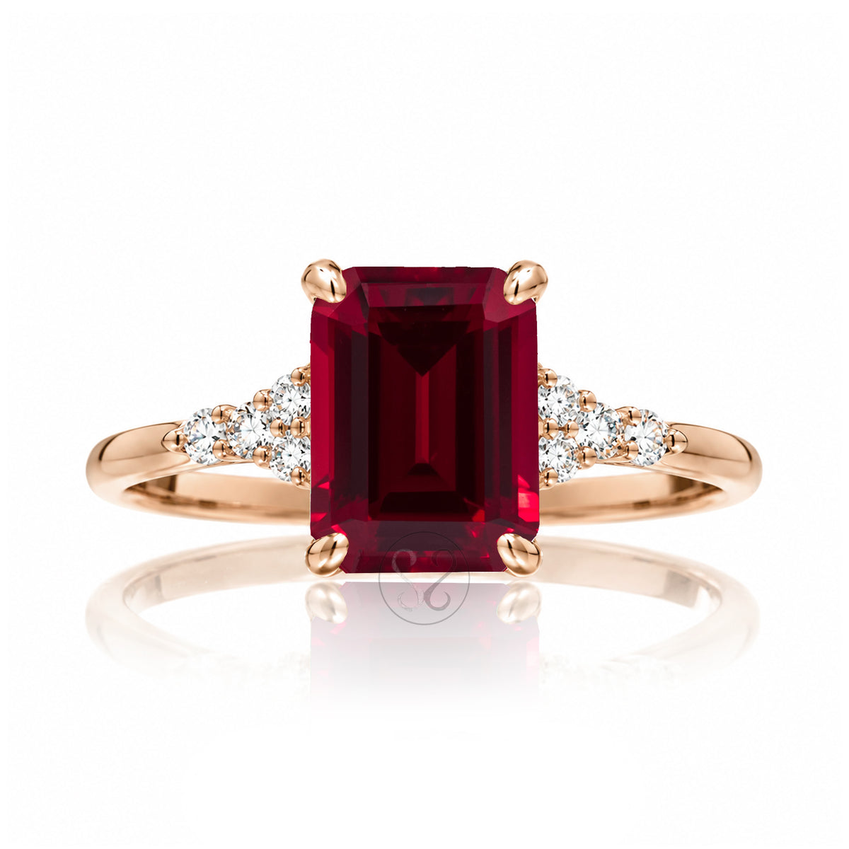 Emerald cut ruby and diamond three stone ring in rose gold