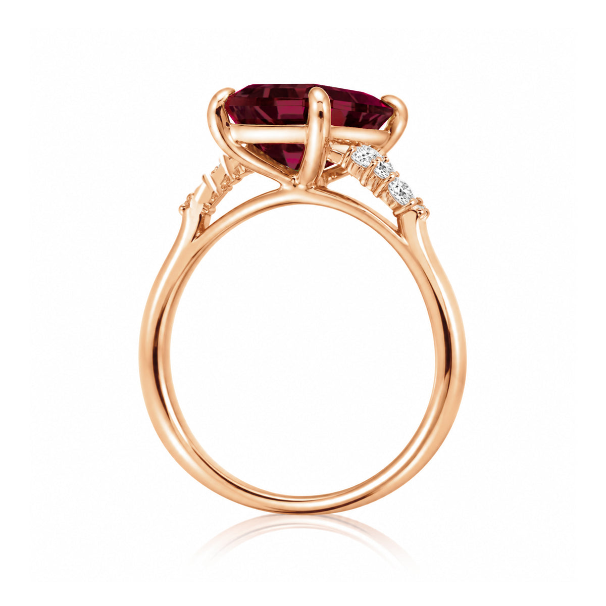 Emerald cut ruby and diamond three stone ring in rose gold