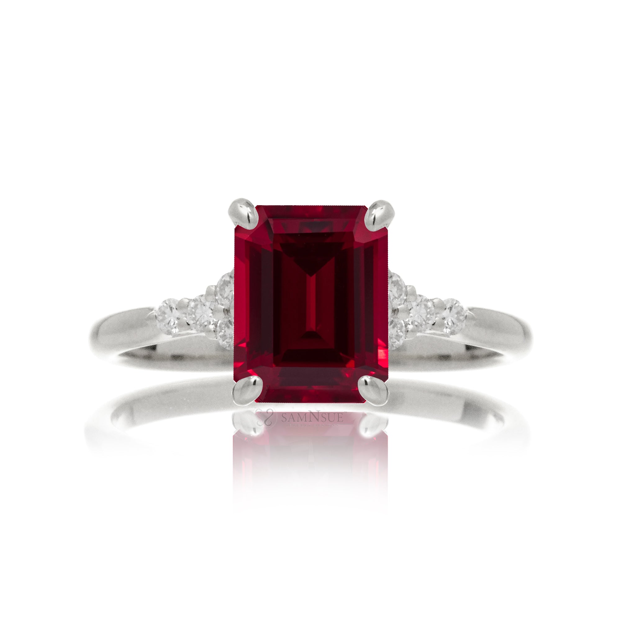 Emerald cut ruby and diamond three stone ring in white gold