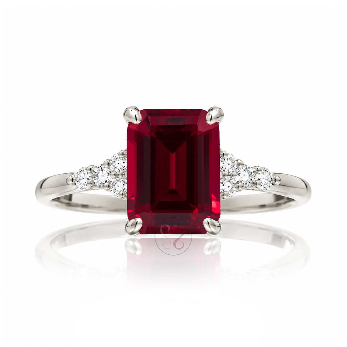 Emerald cut ruby and diamond three stone ring in white gold