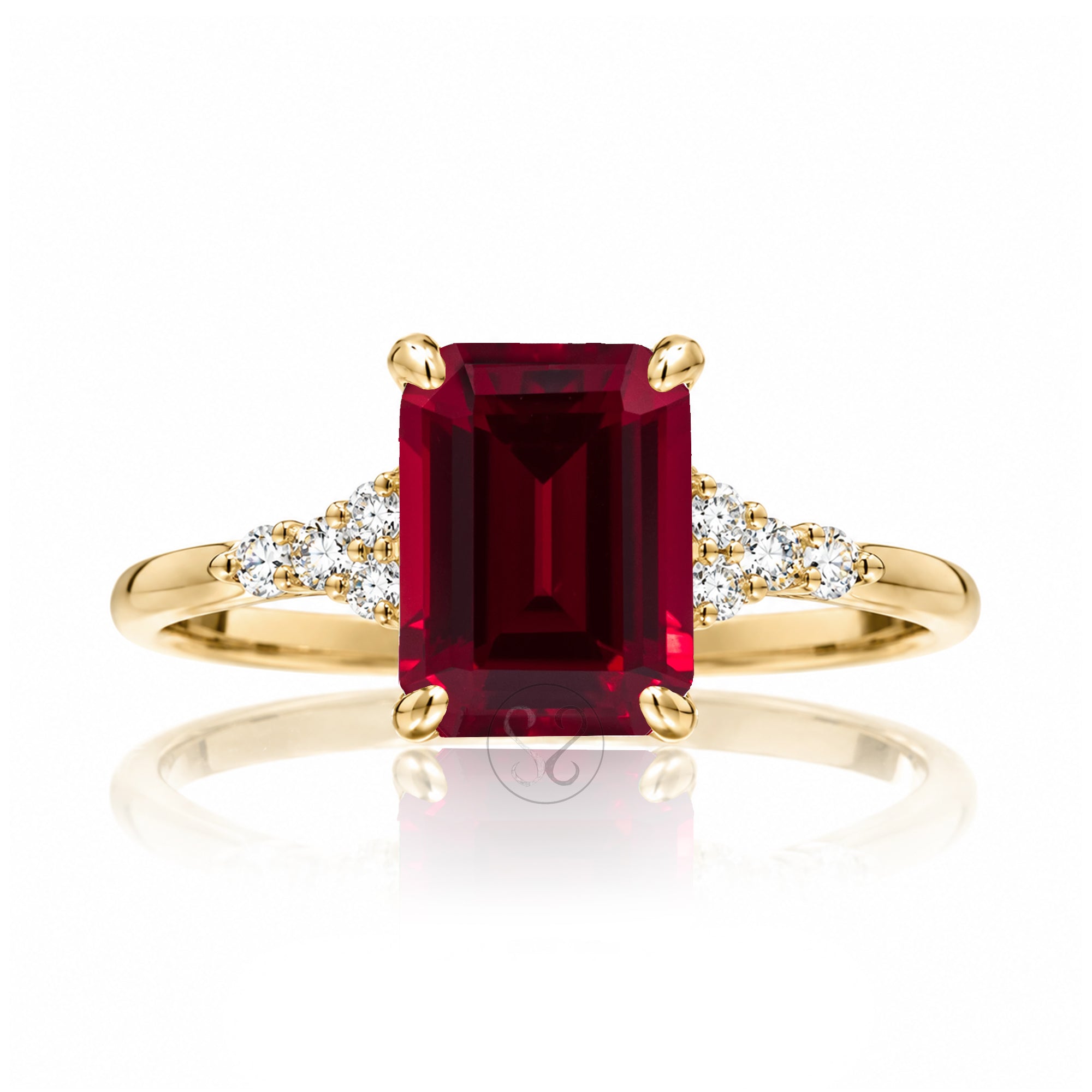 Emerald cut ruby and diamond three stone ring in yellow gold