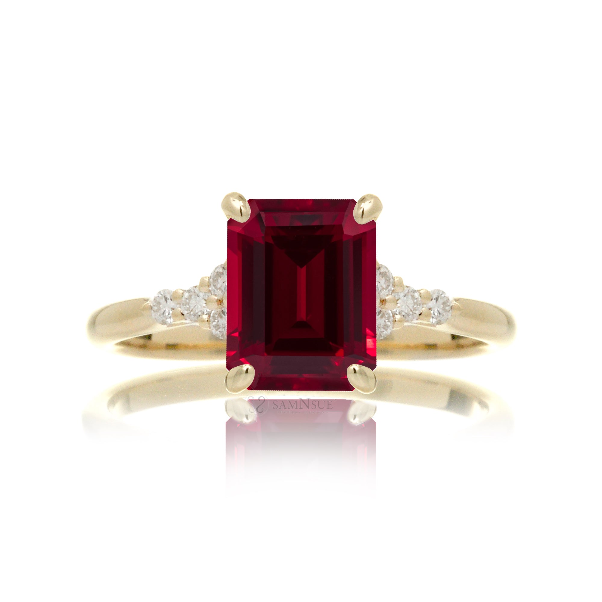 Emerald cut ruby and diamond three stone ring in yellow gold