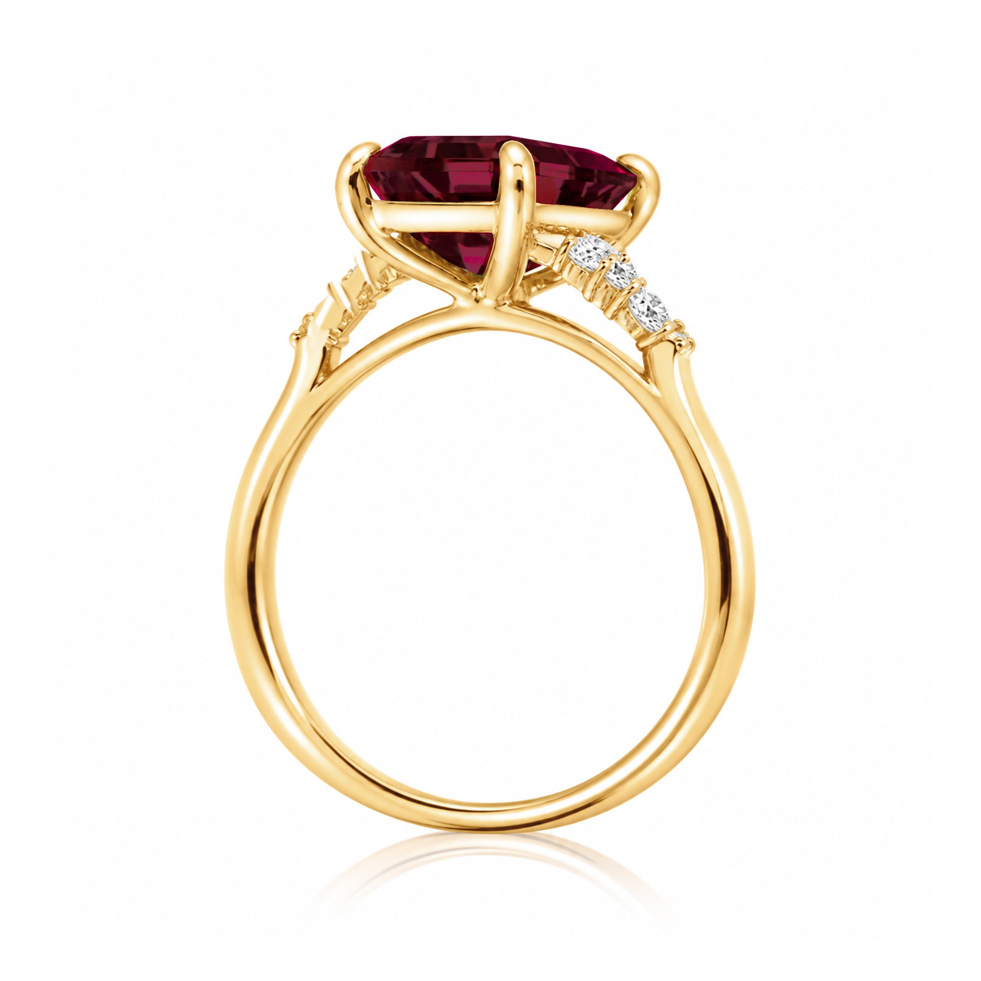 Emerald cut ruby and diamond three stone ring in yellow gold