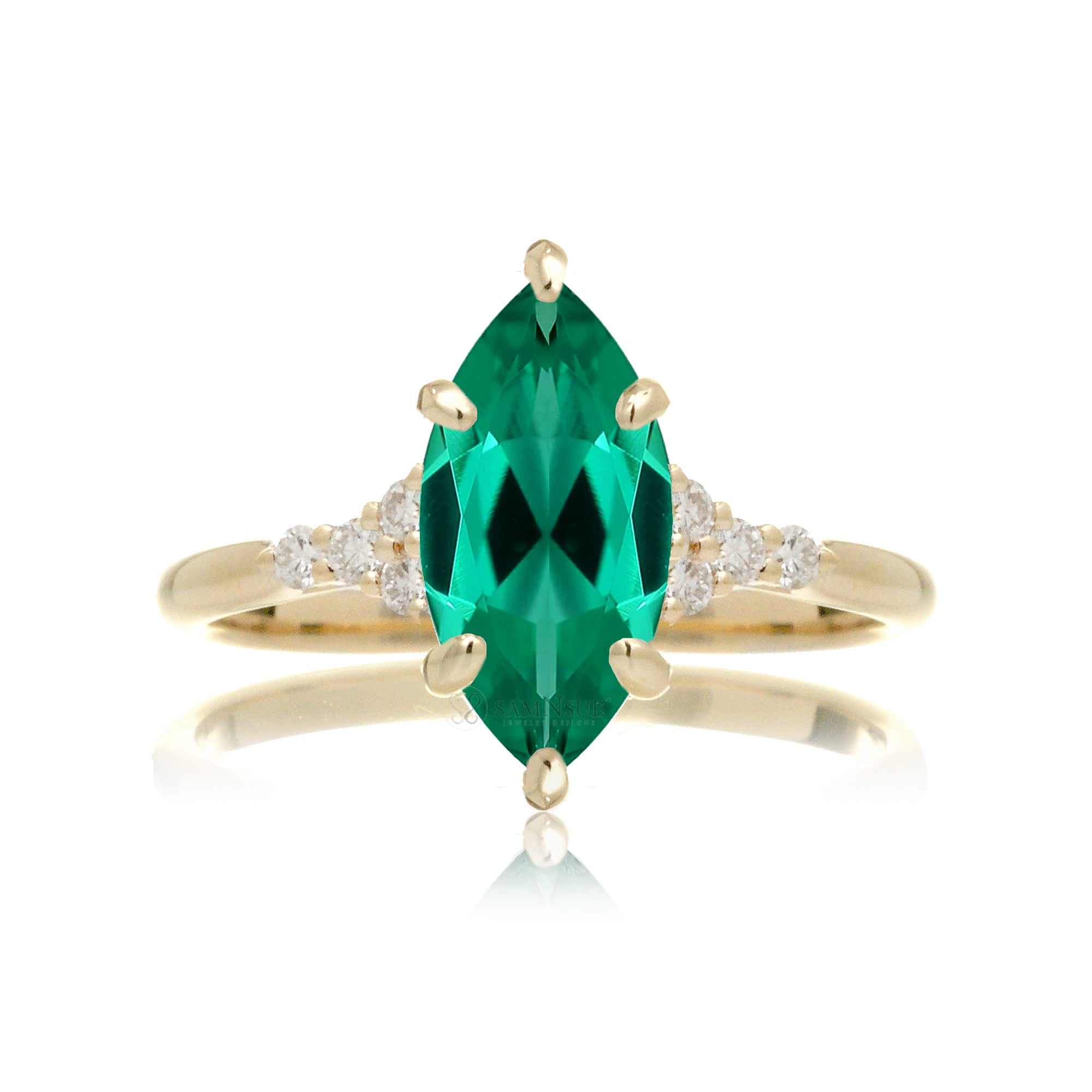 A marquise cut emerald ring with side diamond accents, set in a gold band.