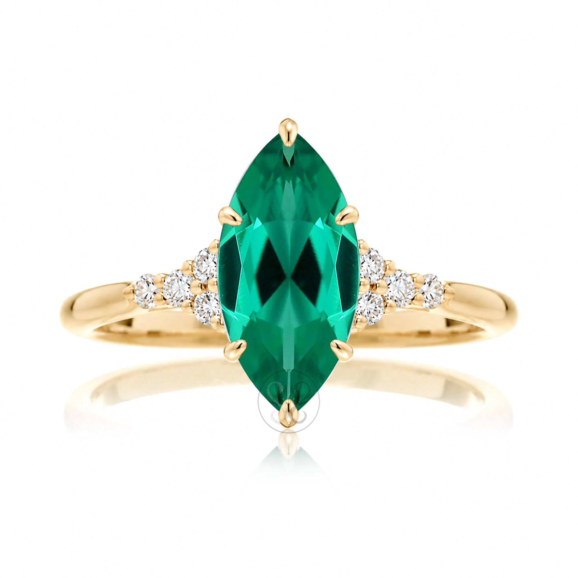 A marquise cut emerald ring with side diamond accents, set in a gold band.
